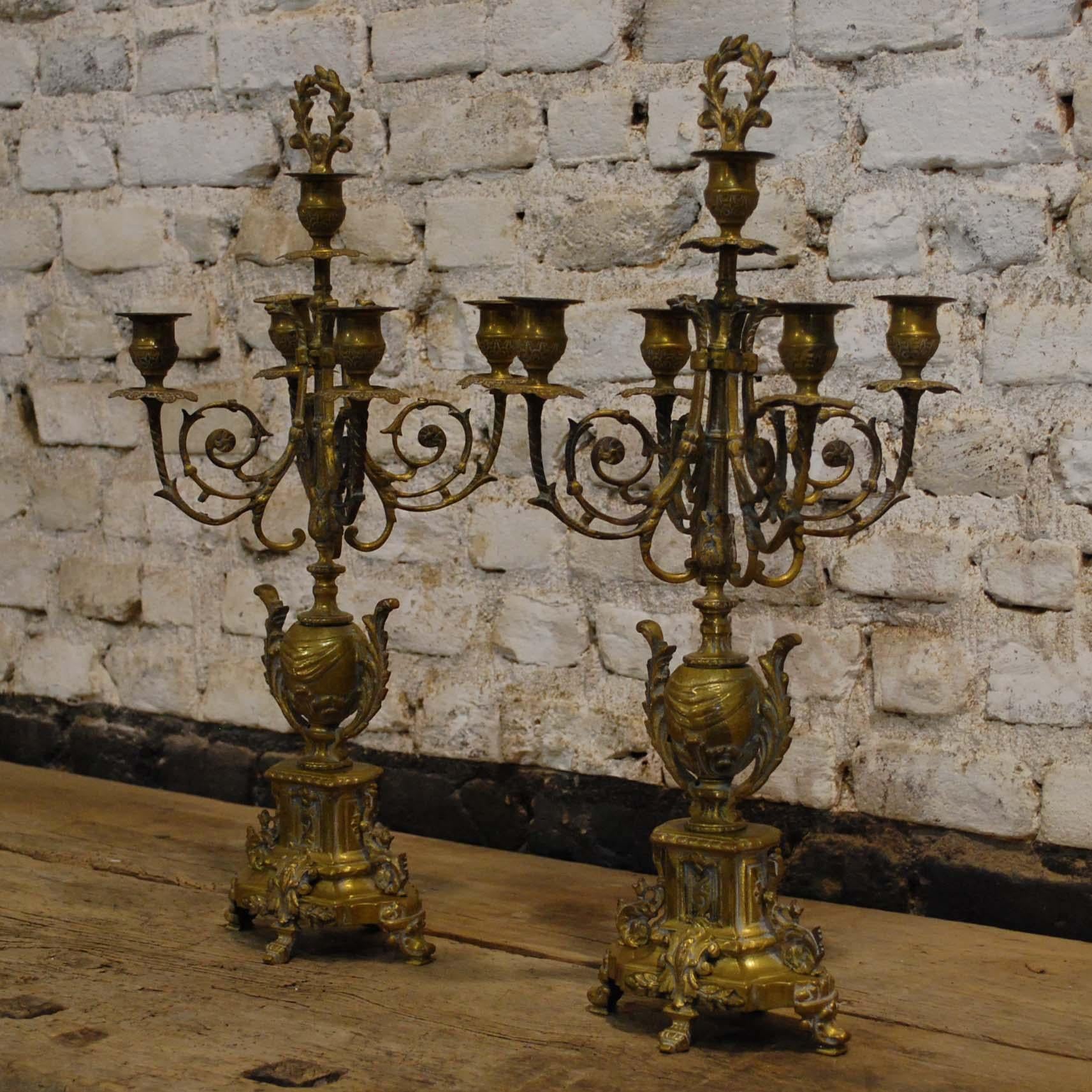 A beautiful fine quality pair of French brass candelabras in Louis XVI style. The five-light candelabra are made from casted ornaments put together on a central spine. The candelabras are richly decorated with acanthus borders and scrolls, foliate