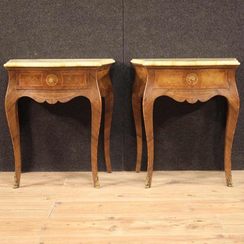 Pair of Italian bedside tables from 20th century. Furniture nicely inlaid in walnut, palisander, rosewood, burl and fruitwood. Louis XV style high leg nightstands equipped with a front drawer and marble top. One marble has a small chip in one corner