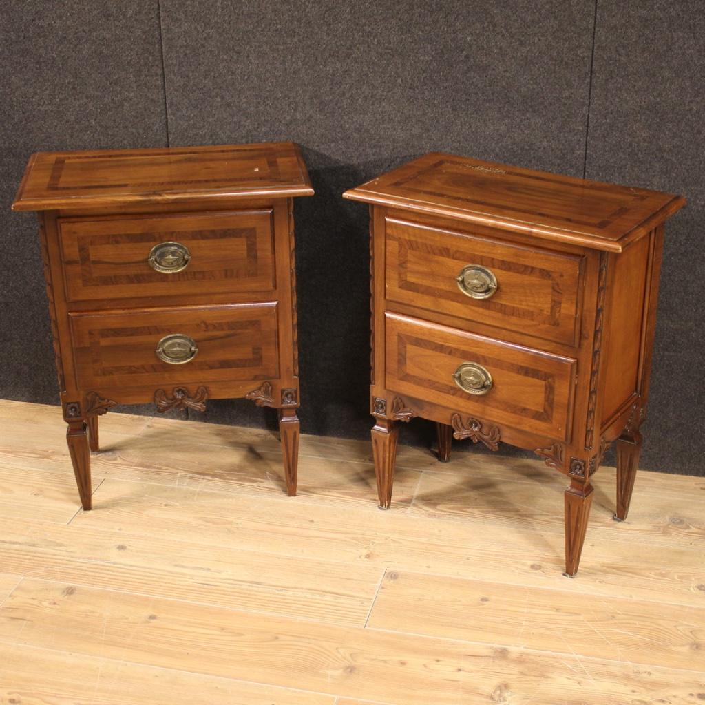 Pair of Italian bedside tables from 20th century. Furniture carved and inlaid in exotic wood and fruitwood in Louis XVI style. Nightstands equipped with two front drawers of good capacity and wooden top in character. Ideal furniture to be placed in