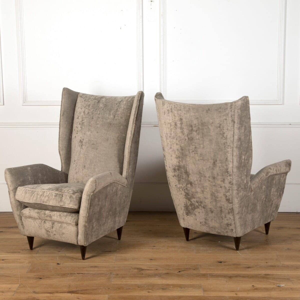 A pair of mid-20th century Italian upholstered armchairs, design attributed to Gio Ponti (1891-1979) and manufactured by ISA Bergamo. Velvet upholstery by GP and J Baker.