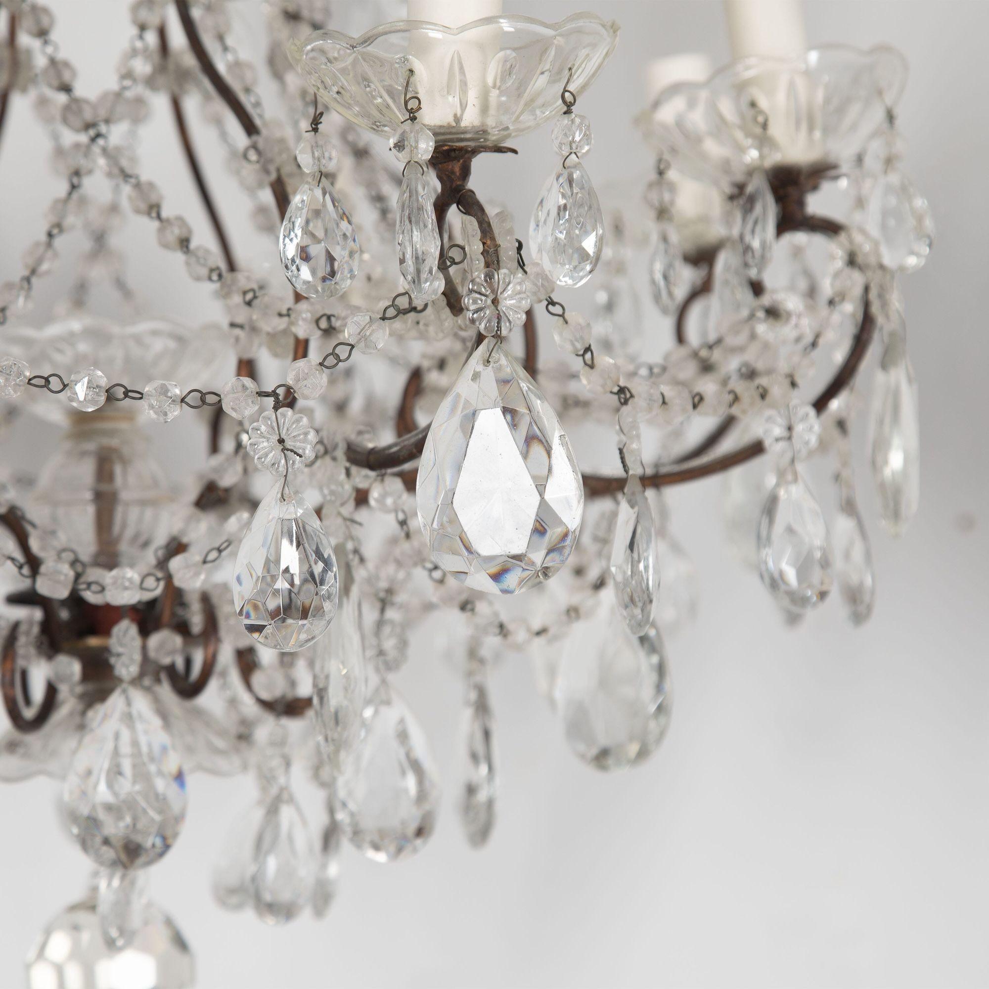Pair of 20th Century Italian chandeliers with bronzed metal frame and glass drops.
These chandeliers have been rewired to current UK standards.