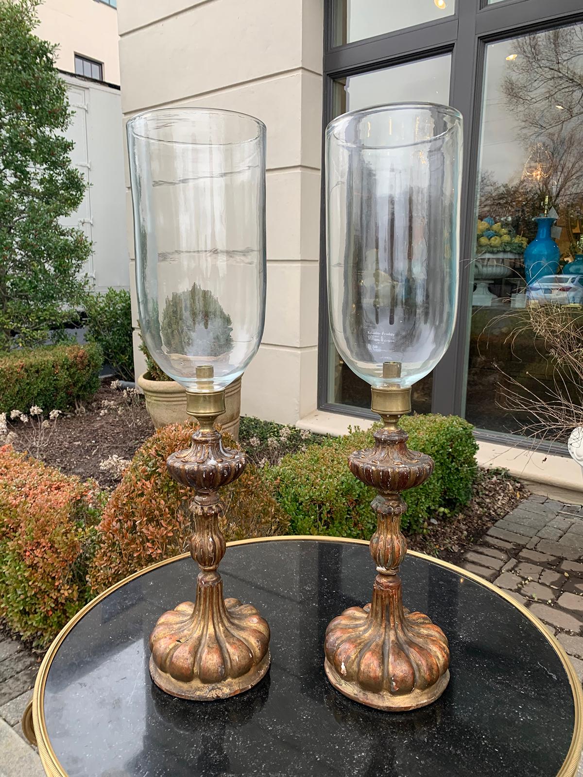 Pair of 20th century Italian giltwood candlesticks with hand blown glass photophores, circa 1930s.