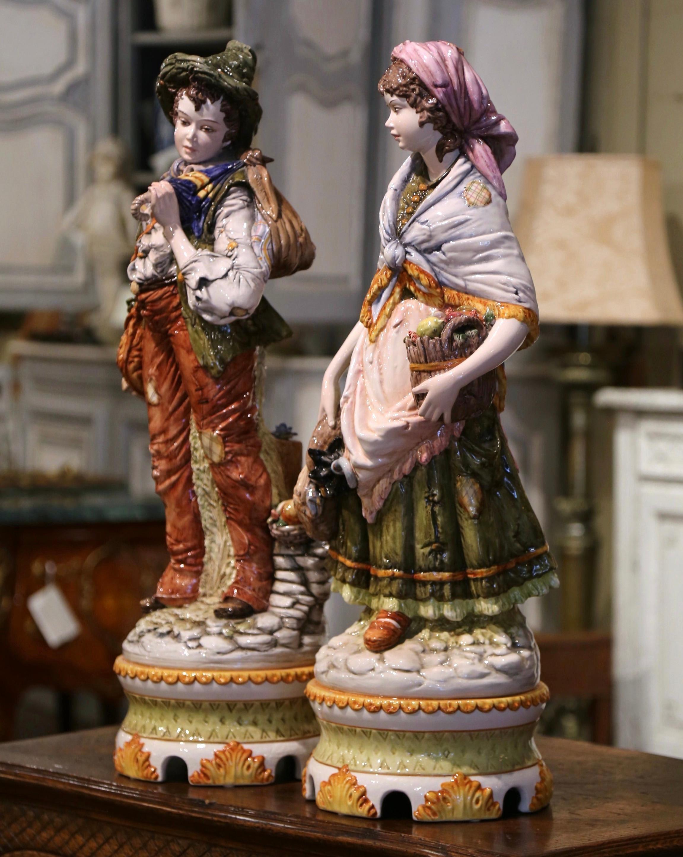 This beautiful pair of majolica figurines would elevate any living room, kitchen, or entry way. Created in Italy circa 1950 and done in the Capodimonte style, the large barbotine statues depict a couple of young adults in traditional Italian