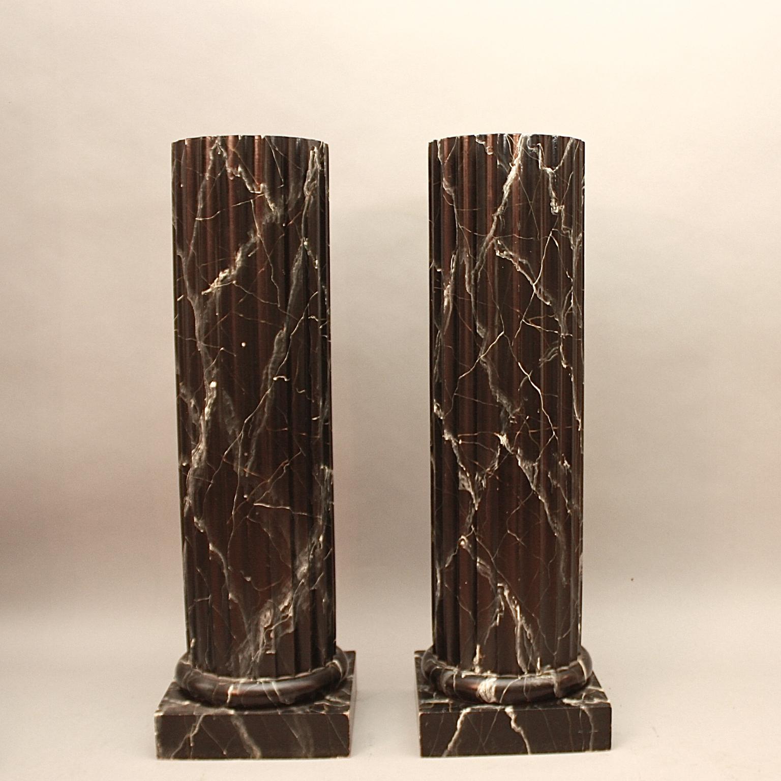 Pair of 20th Century Italian Neoclassical Ionic Order Painted Black Faux Marble Columns or Pedestals

Pair of 20th century Italian painted black faux marble columns or pedestals, each with a fluted shaft and a base enriched with mouldings resting on