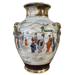 Pair of 20th Century Japanese Satsuma Vases with gilded lion head accents