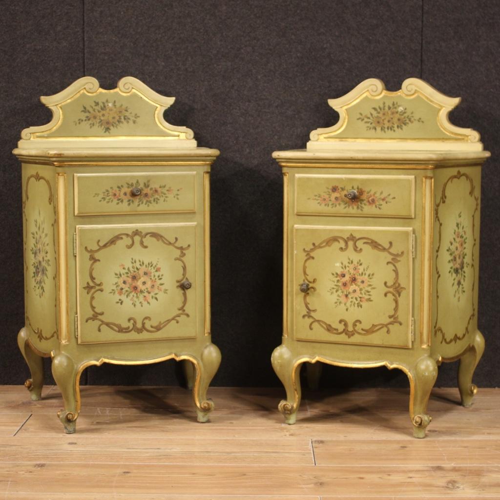 Pair of Italian bedside tables from the mid-20th century. Furniture in lacquered, gilded and hand painted wood with very pleasant floral decorations. Bedside tables equipped with a drawer and a good capacity door. Wooden top in character adorned