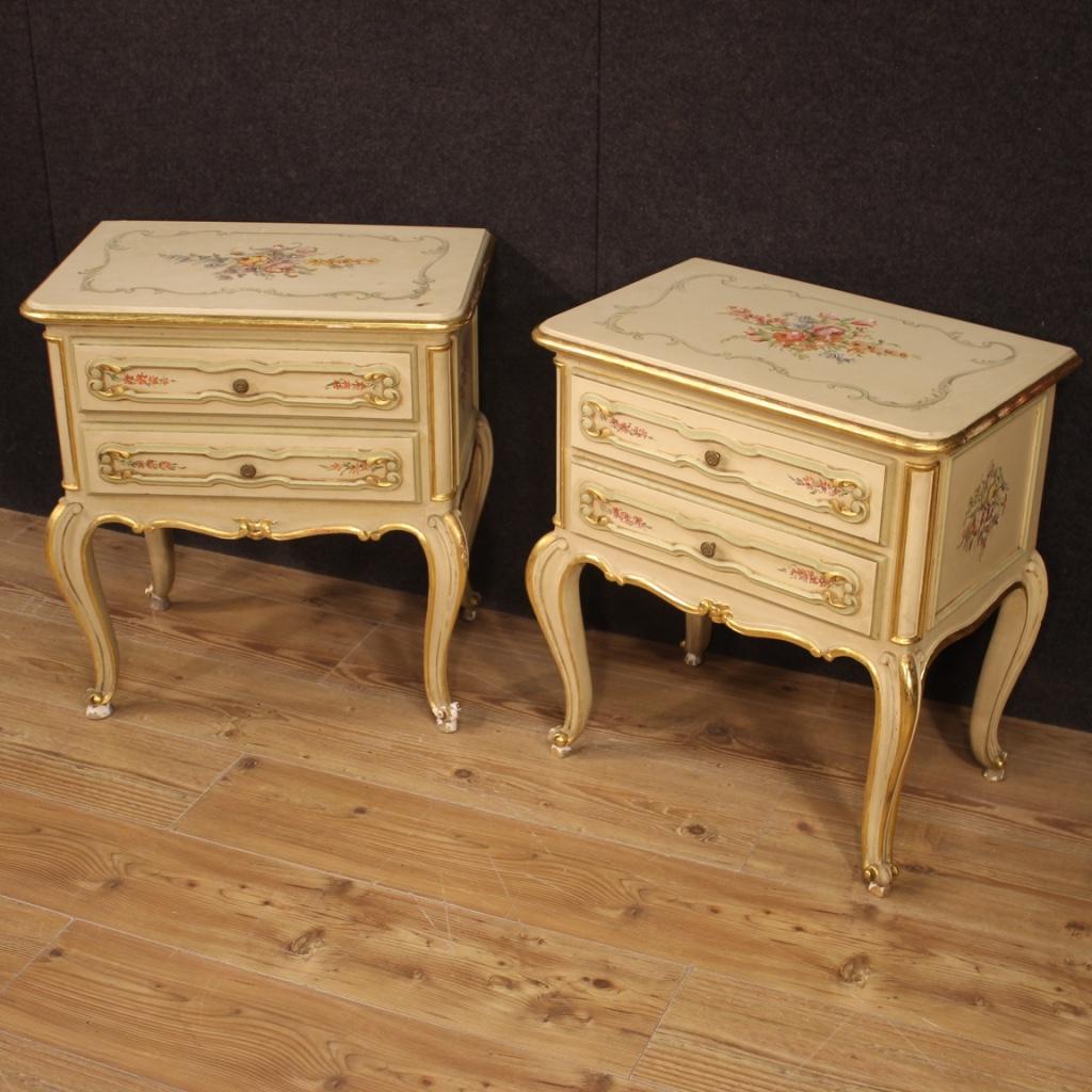 Pair of Venetian bedside tables from 20th century. Carved, lacquered, gilded and hand painted wooden furniture with very pleasant floral decorations. High leg bedside tables with curly feet equipped with two drawers each, of good capacity. Wooden