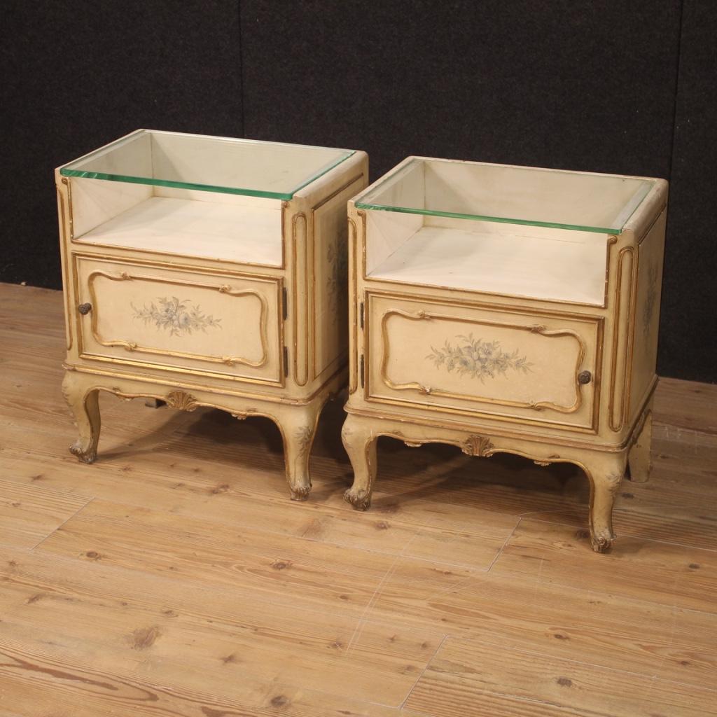 Pair of French bedside tables from 20th century. Nicely lacquered, gilded and painted furniture with floral decorations. Small size nightstands equipped with front door and upper top in glass of discreet service. A glass top has been replaced and is