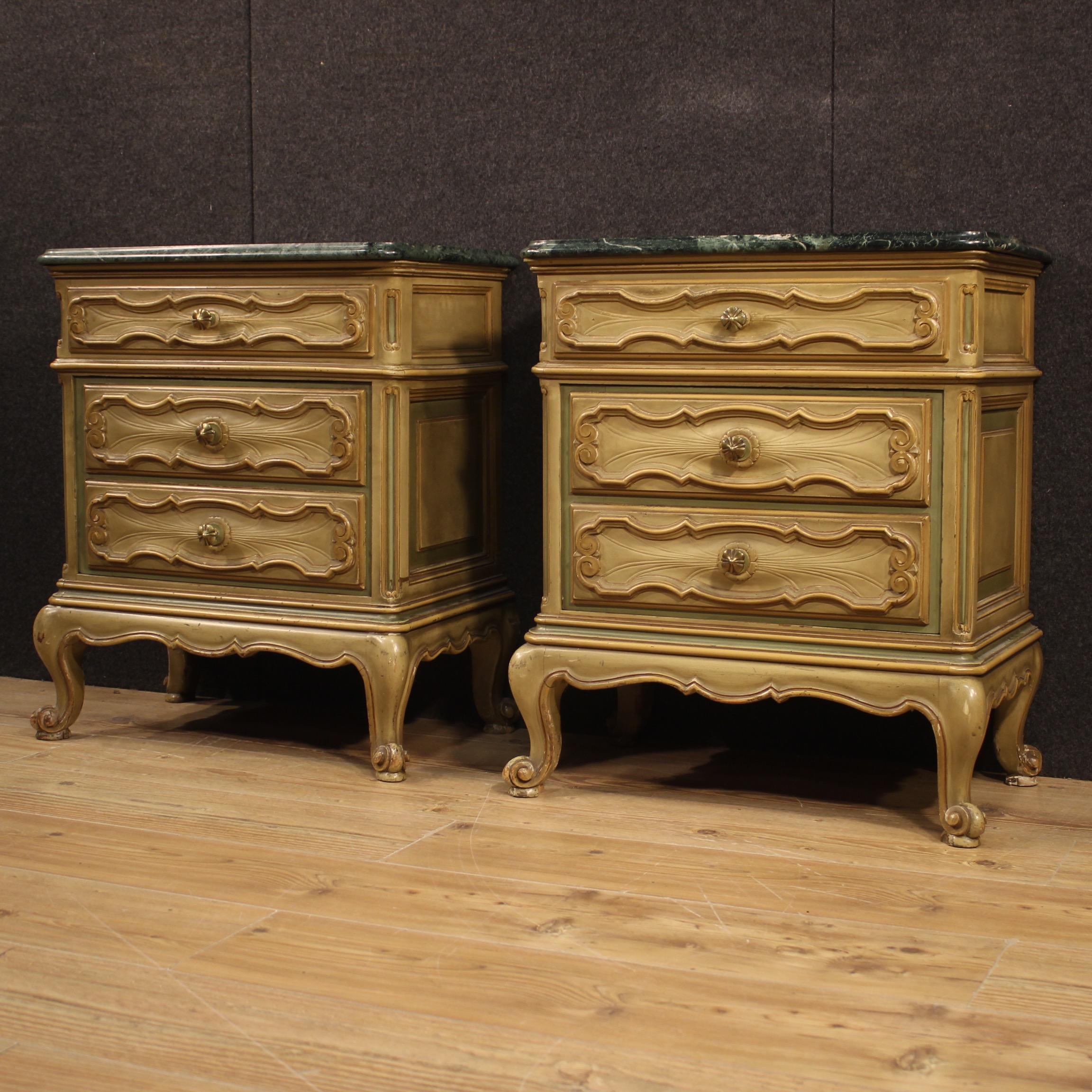 Pair of Italian bedside tables from the 20th century. Carved and lacquered wooden furniture in Baroque style of beautiful lines and pleasant decor. Bedside tables with original marble top of beautiful size and service. A marble has undergone a