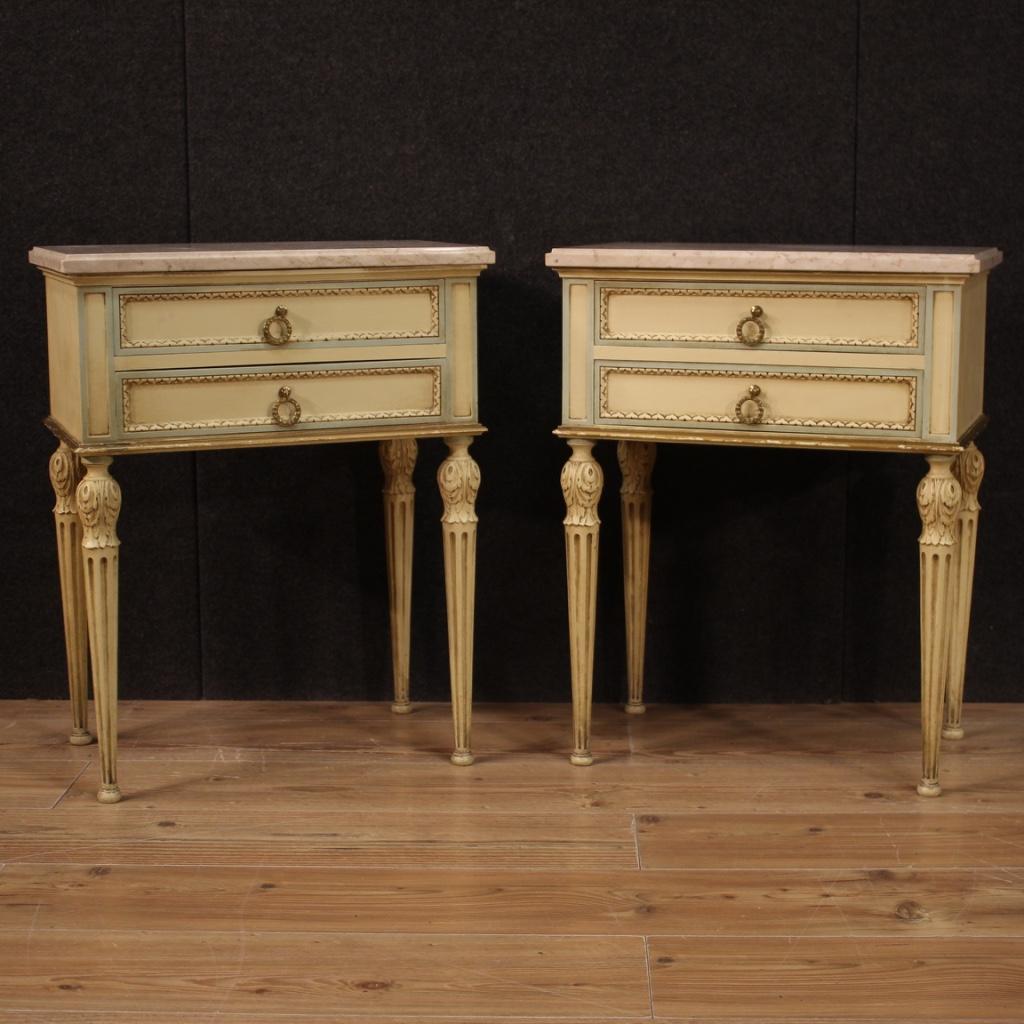 Pair of Italian bedside tables from the 20th century. Furniture of beautiful line and pleasant decor in carved, lacquered and gilded wood in Louis XVI style. Night stands equipped with two front drawers of good capacity and top in original marble of