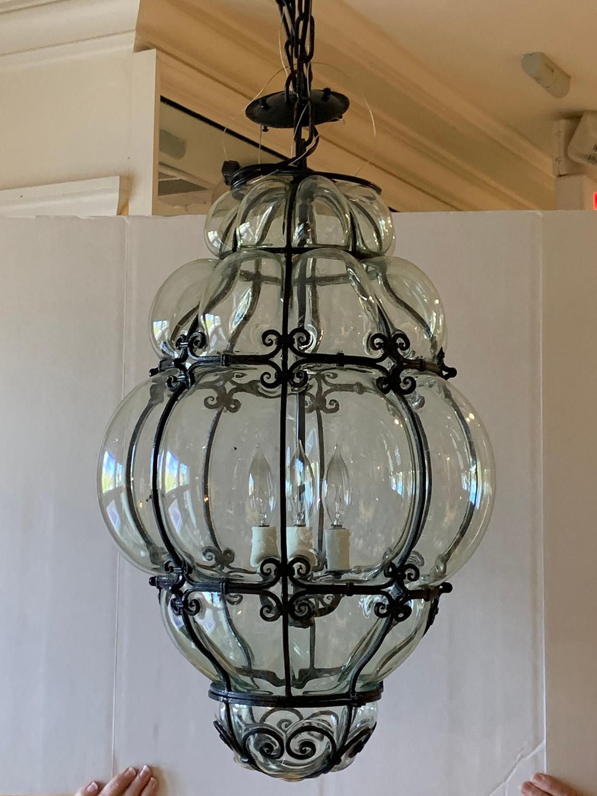 Pair of 20th century large Italian Murano bubble glass iron-bound lanterns
Three light cluster
Glass tinted a faint blue/green not turquoise. The turquoise you see is a reflection of our front door.
Brand new wiring.