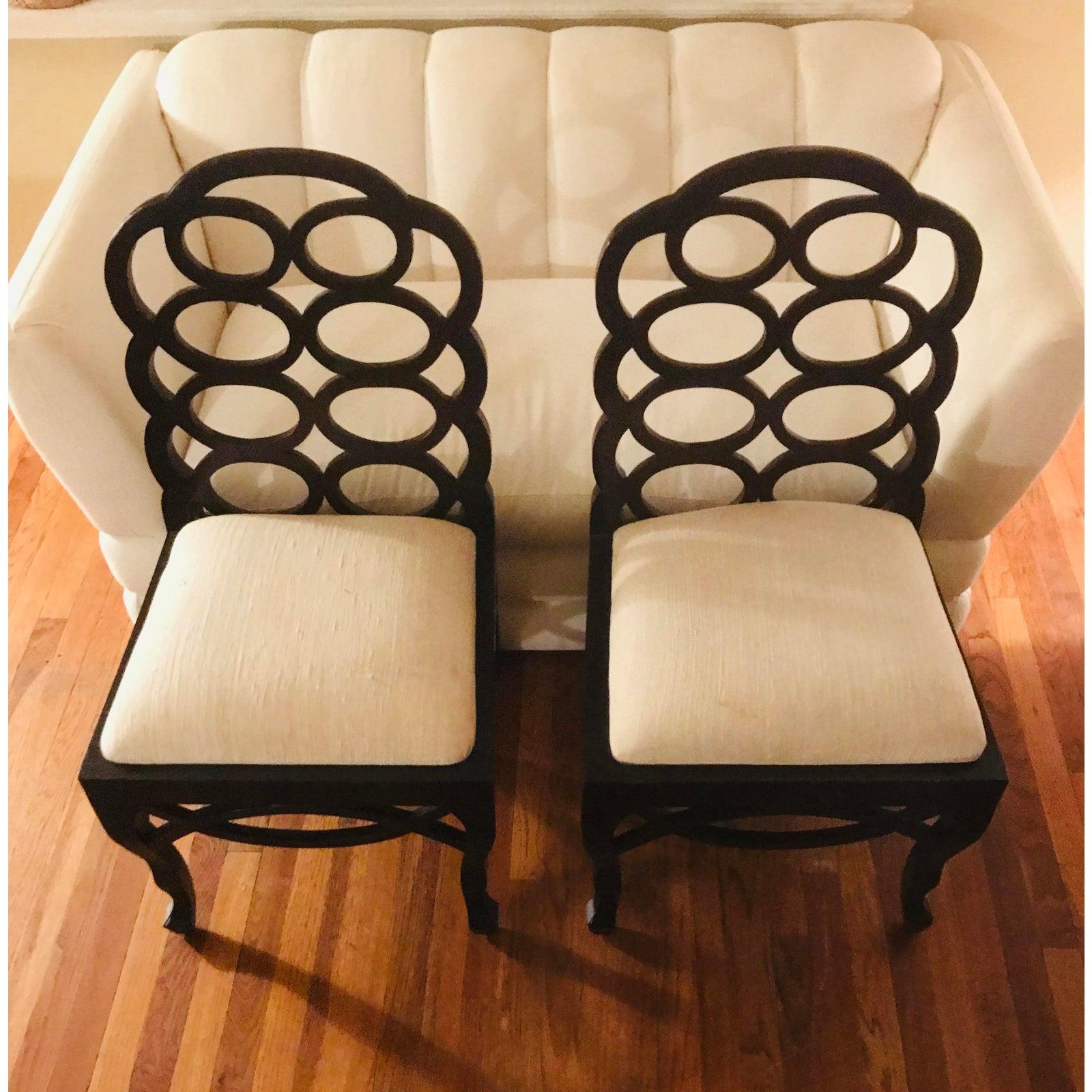 Elkins famously created this looped-back George II-style chair based on designs she found from the 18th century. These are extremely strong well-made chairs that date to the 1960s. Currently upholstered in a heavy ivory linen material.