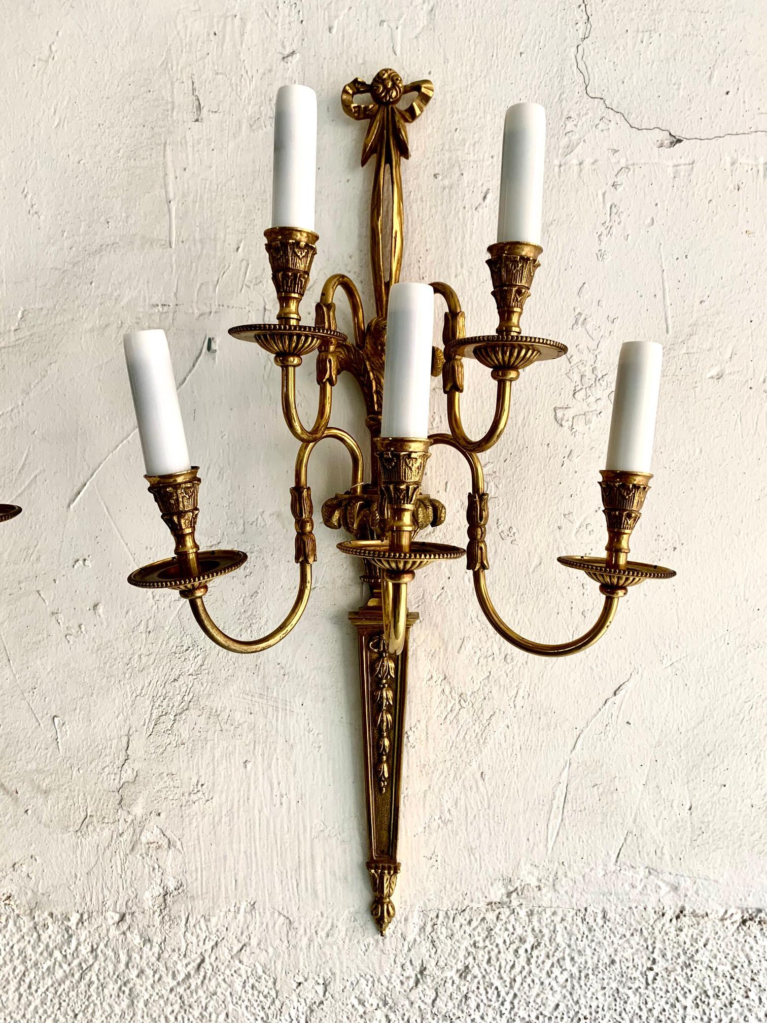 A pair of large Louis XVI style wall sconces, they come from a house decorated in the 50s in Madrid, the sconces have all the usual decorative motifs in this Louis XVI style, the sconces have five light points and work perfectly.