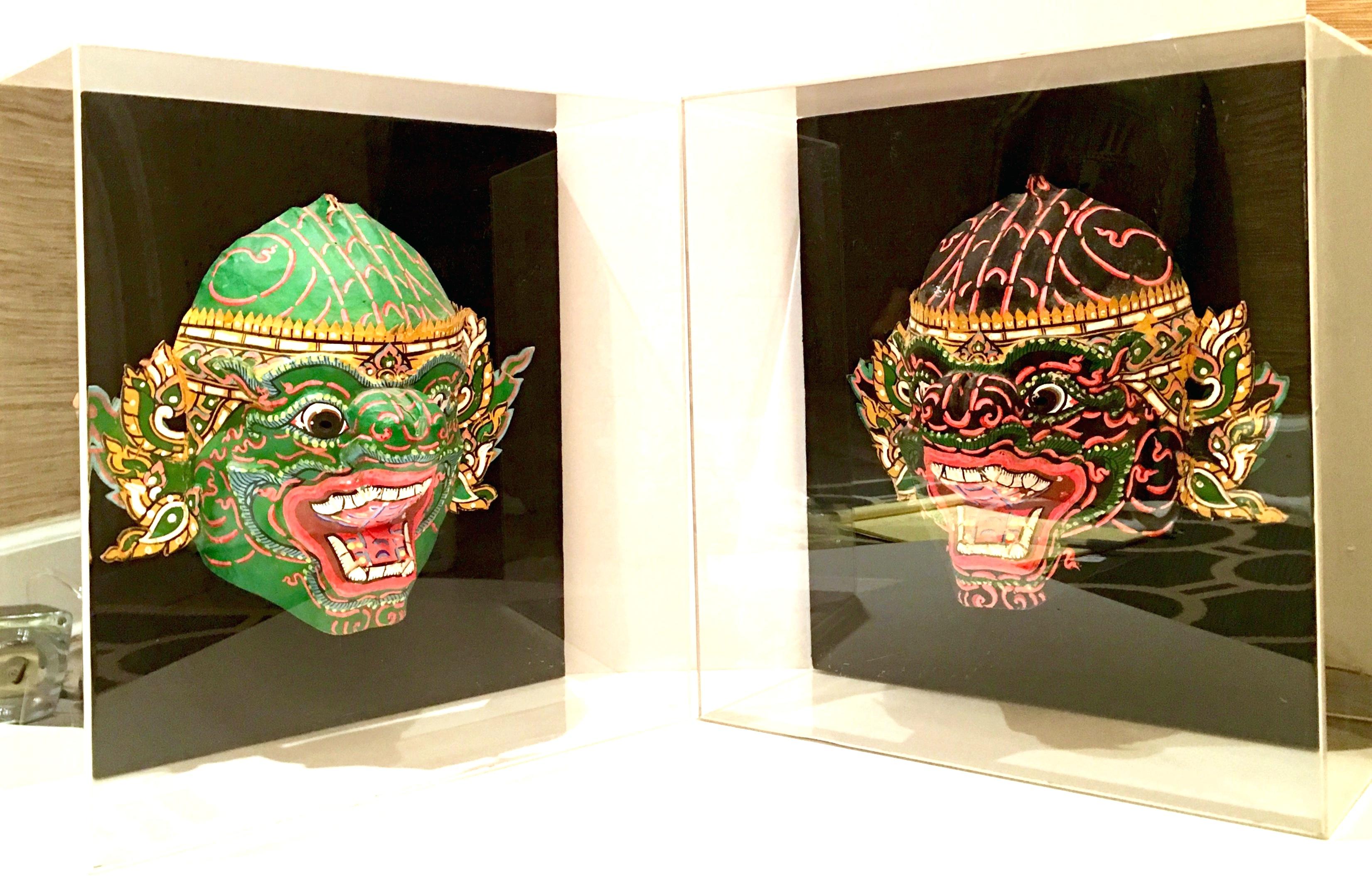 Asian Pair Of 20th Century Lucite Shadow Box Mounted Hand-Painted Tribal Masks For Sale