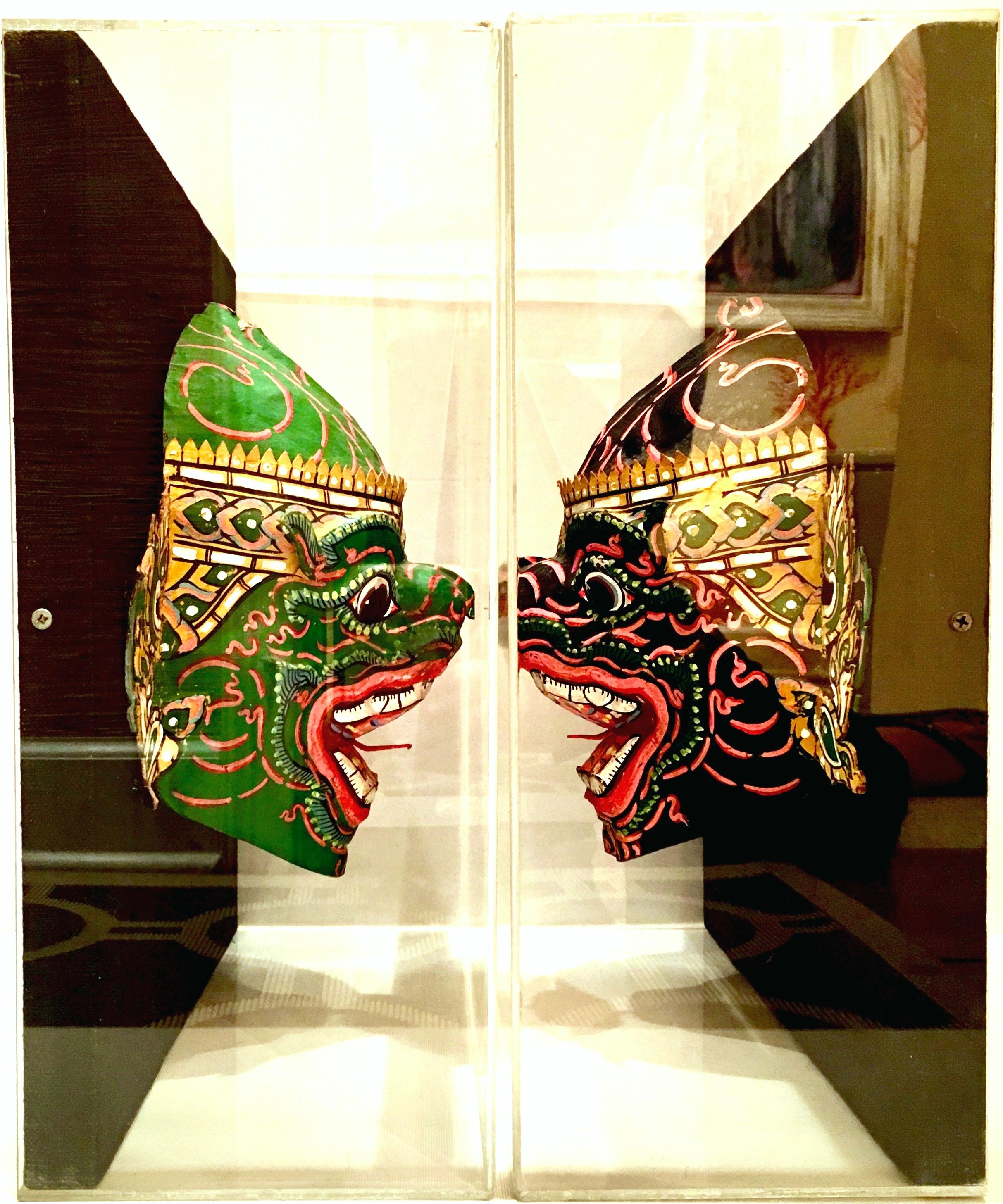 Asian Pair of 20th Century Lucite Shadow Box Mounted Hand Painted Tribal Masks For Sale