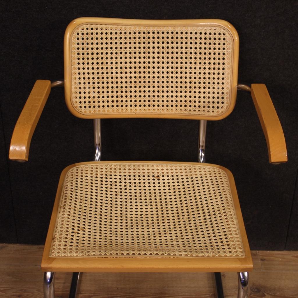 Pair of Italian design armchairs from the 1980s. Furniture with metal and wood structure of beautiful line and good solidity. Armchairs for living room or studio, pleasantly furnished, with seats and backs in cane with some signs of wear. They show