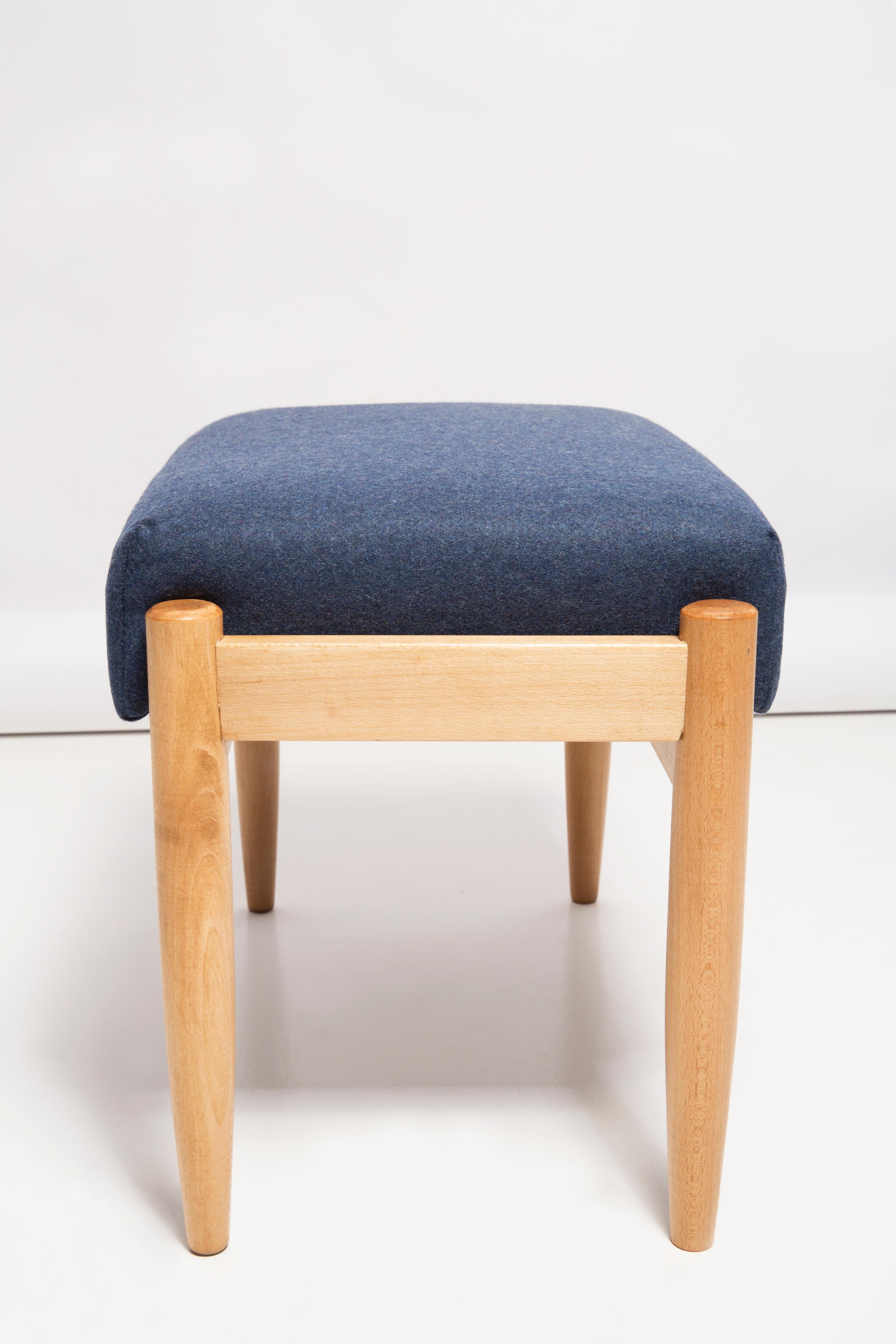 Stools from the turn of the 1960s. Beautiful navy blue high quality wool upholstery. The stools consists of an upholstered part, a seat and wooden legs narrowing downwards, characteristic of the 1960s style. We can prepare this set also in another