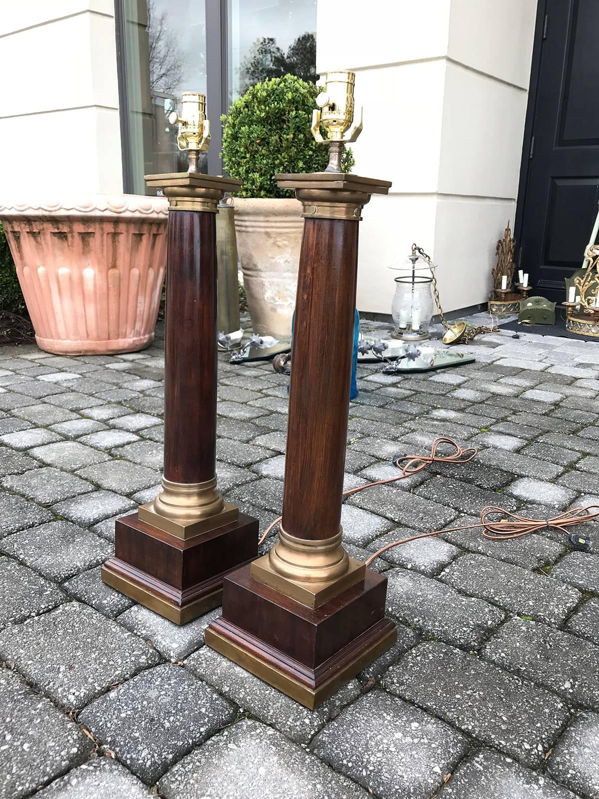 Pair of 20th century neoclassical large brass-mounted wooden column lamps.