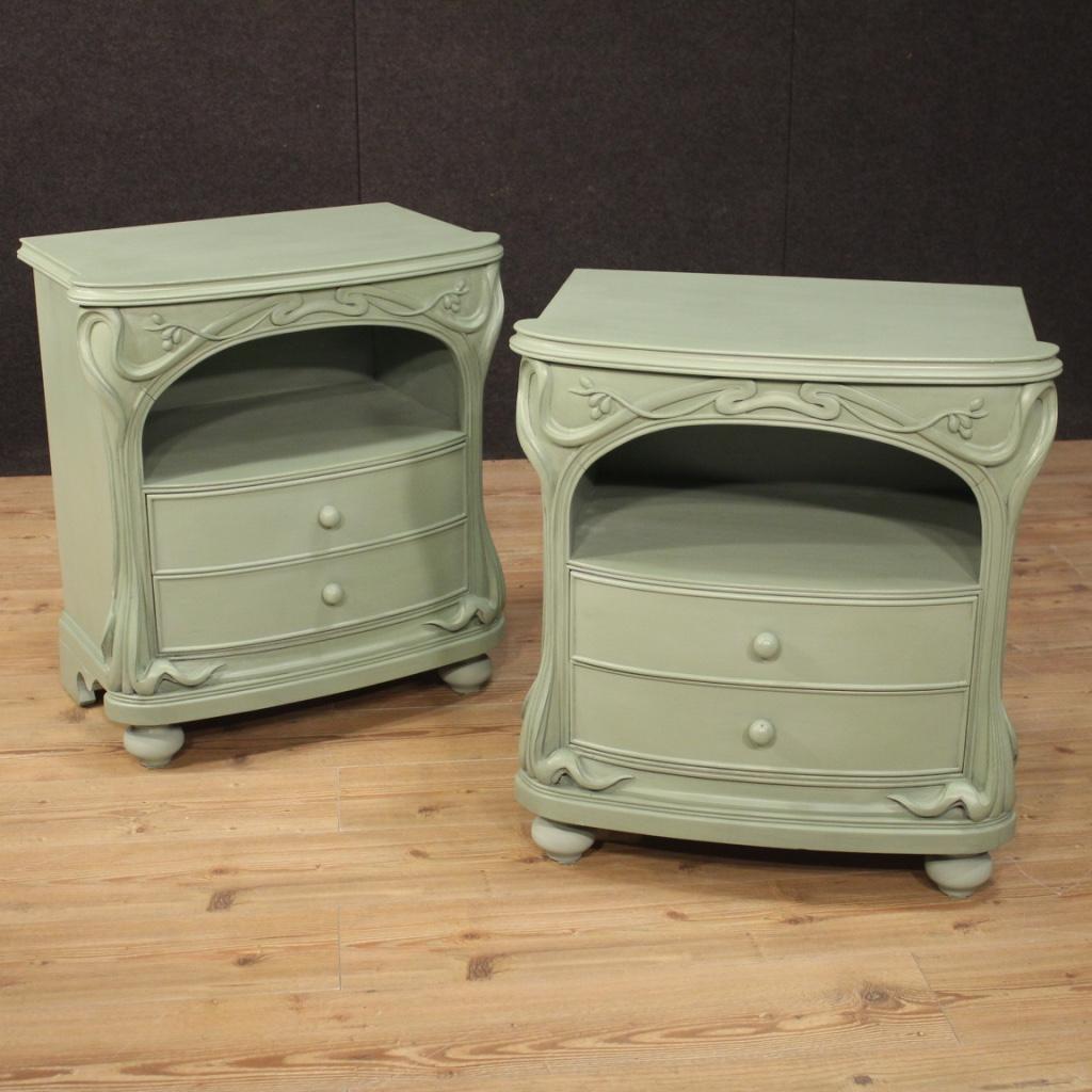 Pair of Italian Art Nouveau style bedside tables from the 1970s-1980s. Carved and painted wooden furniture of beautiful lines and pleasant decor. Bedside tables of great size and impact, ideal to be placed in a bedroom or living room, of excellent