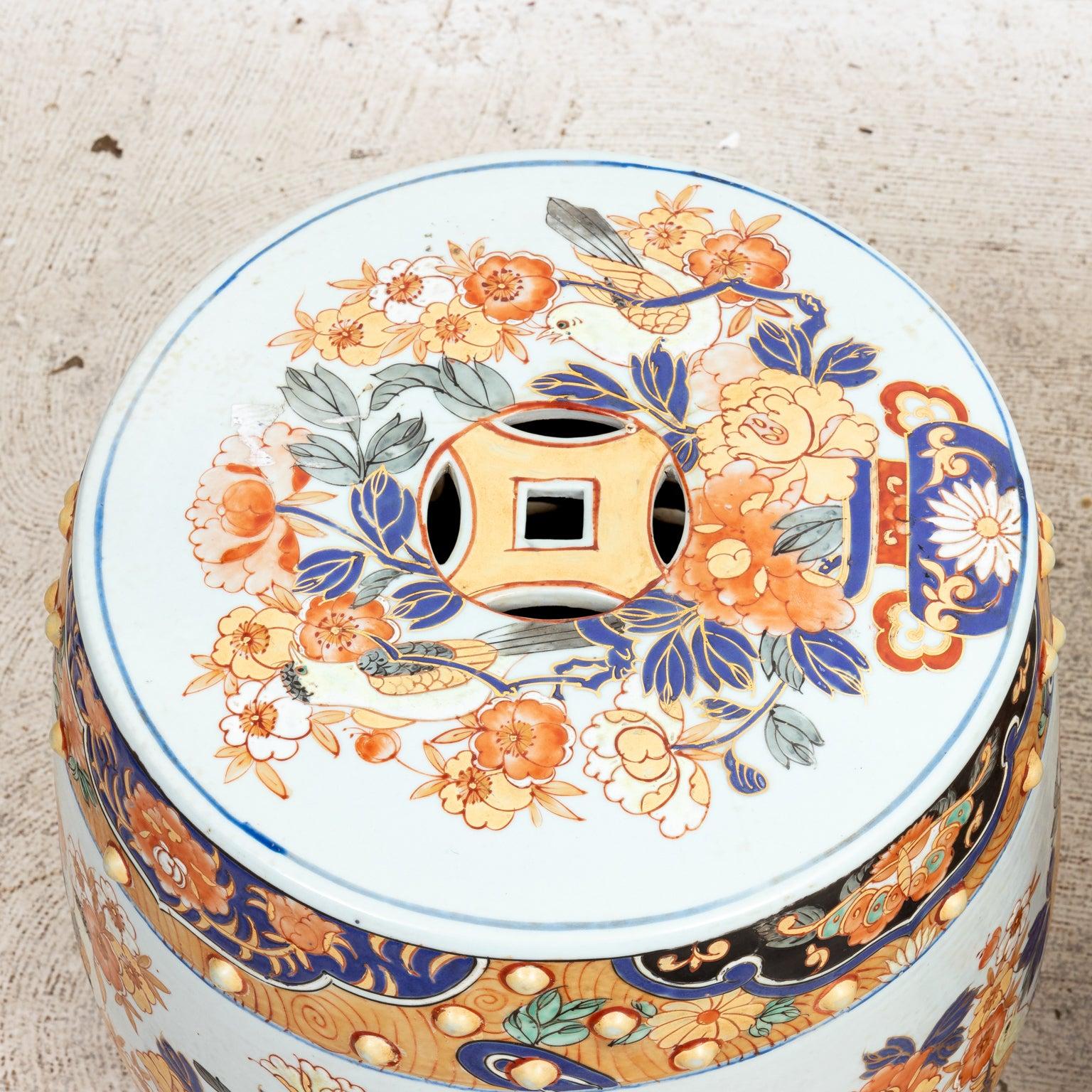 Circa 20th century pair of Chinese style painted Porcelain garden seats with multi-colored floral motifs throughout. Please note of wear consistent with age including minor chips to the paint.