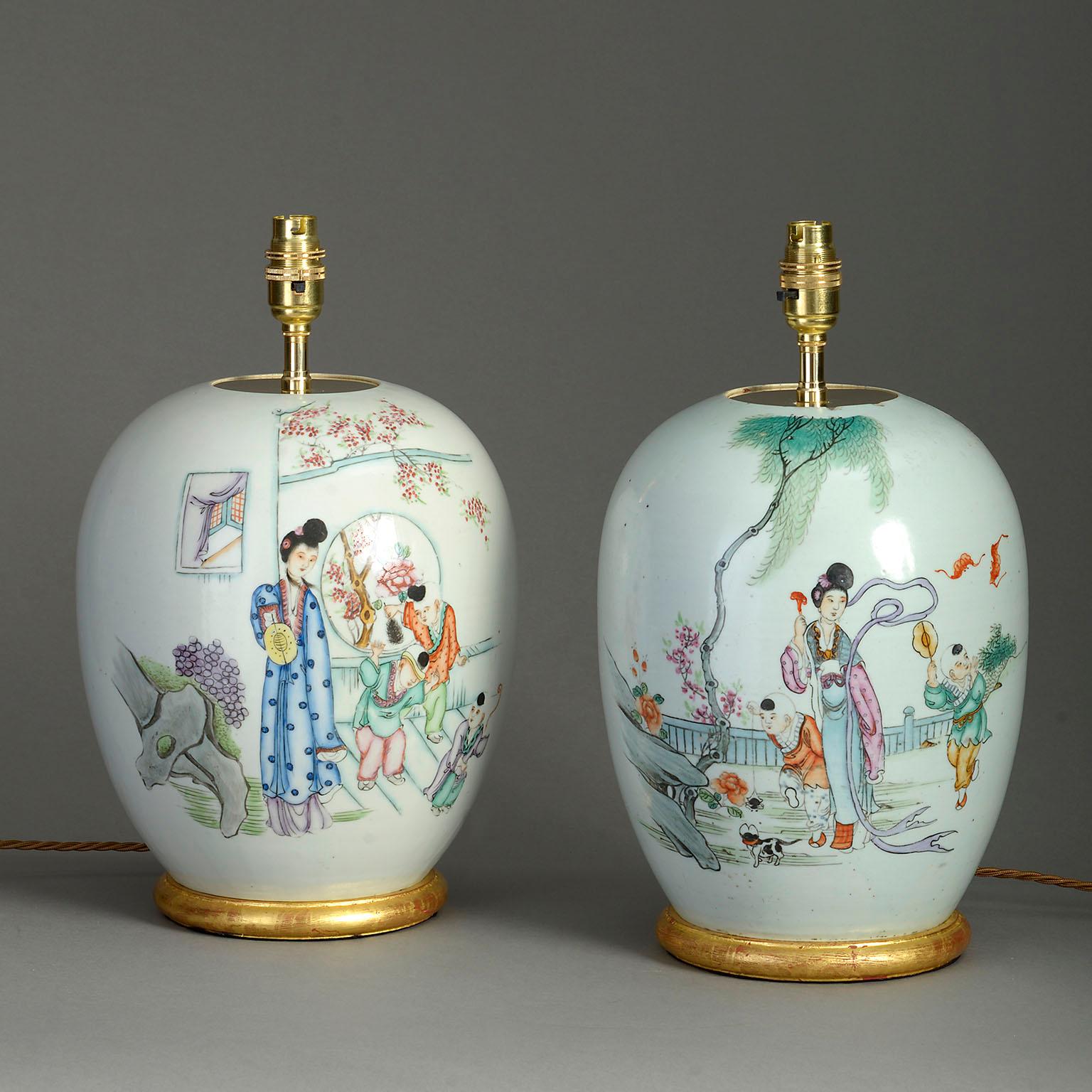 A pair of mid-20th century porcelain jars, of bulbous form, decorated with courtly ladies, the reverse sides with Chinese characters. Now mounted as lamps on giltwood bases.

Republic Period.

Dimensions refer to jars and bases.

Shades not