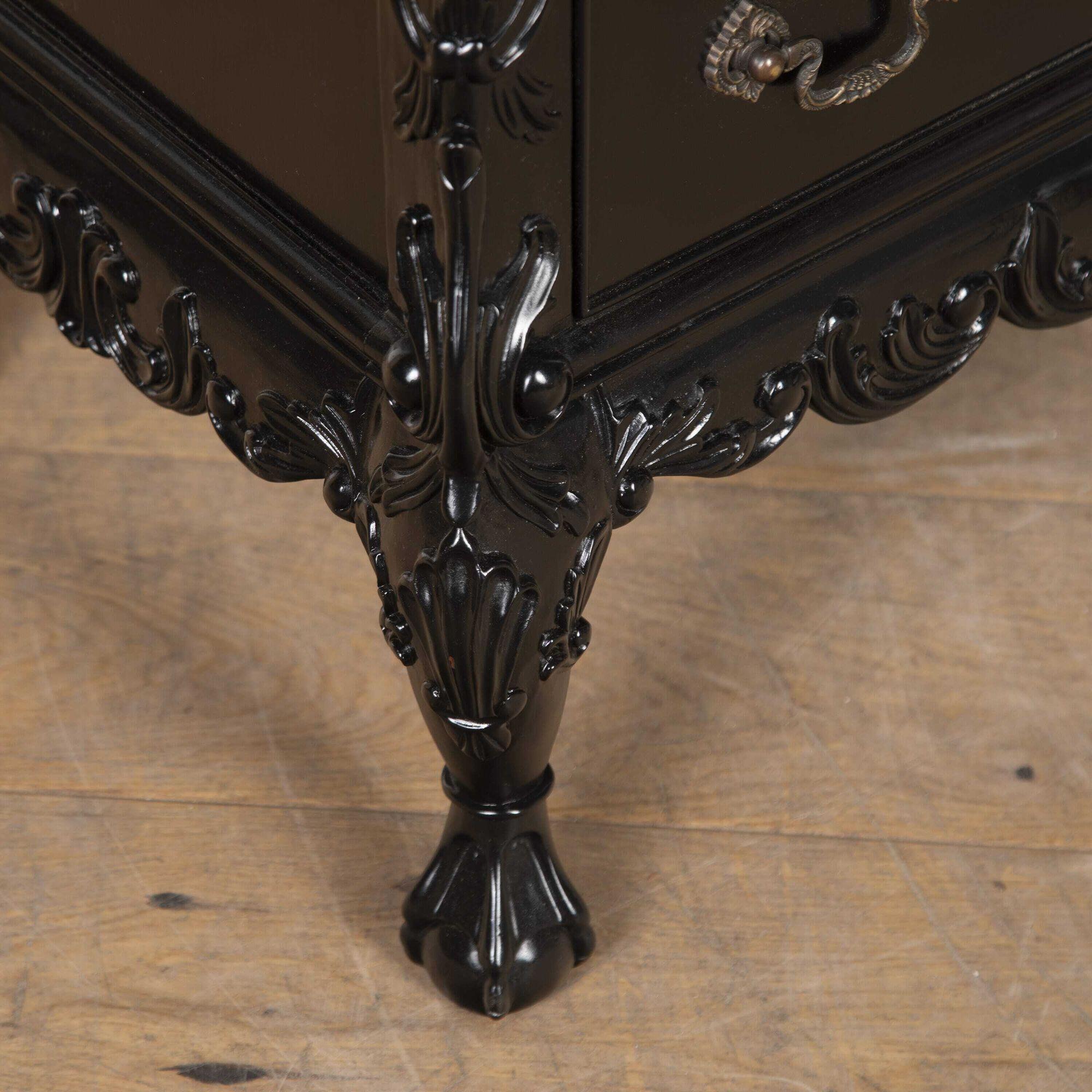 Pair of Mid 20th Century black lacquer commodes in the rococo revival manner.
Both are fitted with three drawers and brass hardware with foliate carving and ball and claw feet. In exceptional condition, ideal for placing either end of a sofa or
