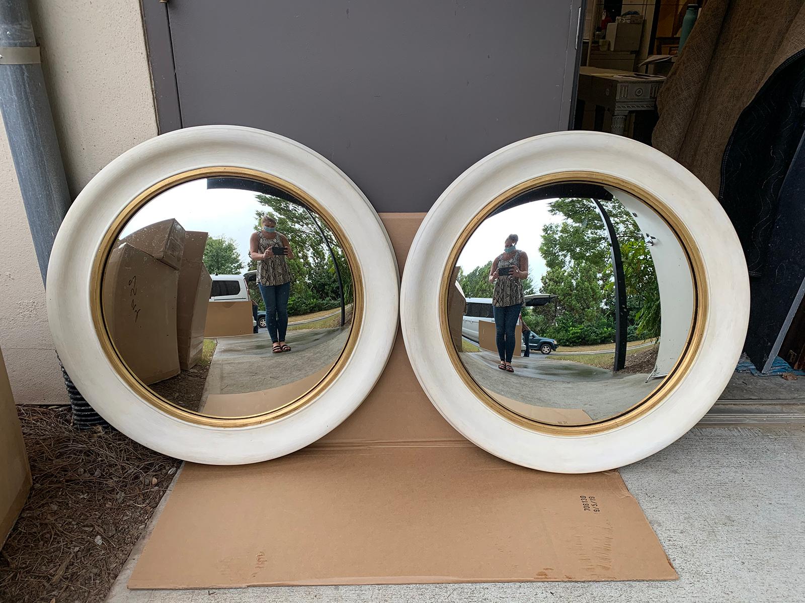 Pair of 20th century round convex mirrors with custom hand painted finish.