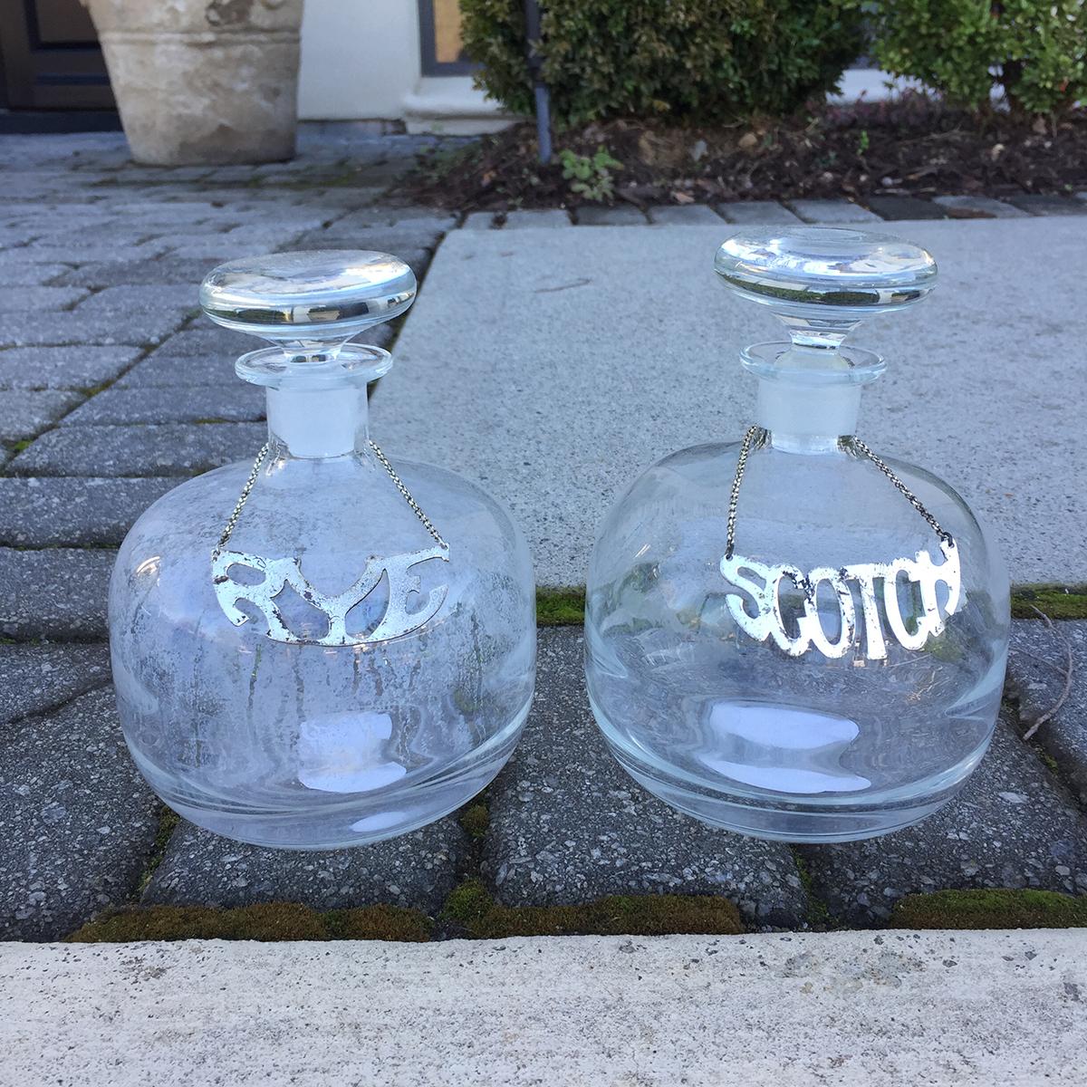 Pair of 20th century scotch and rye glass decanters.