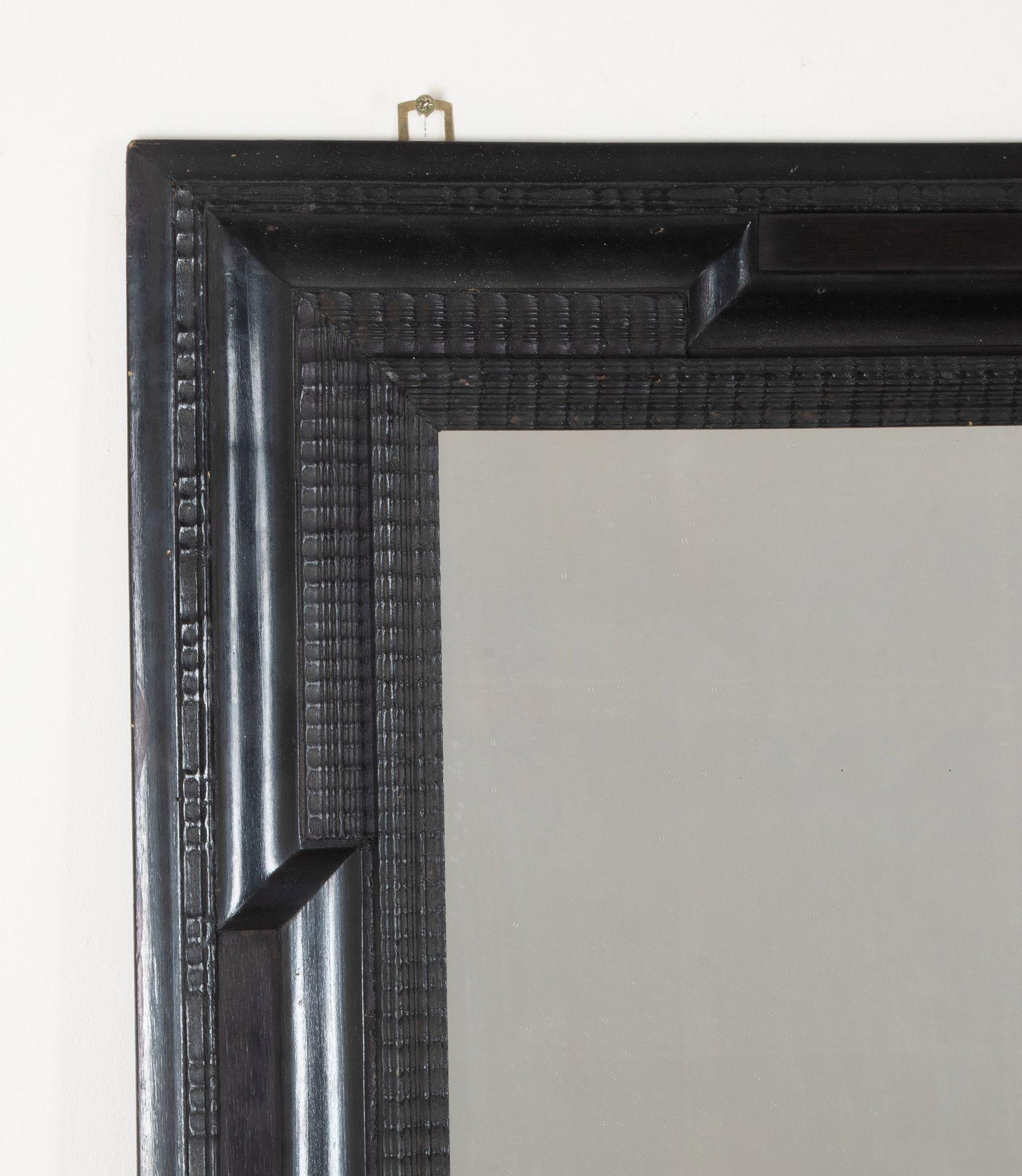 A stylish pair of early 20th Century Spanish ebonised ripple moulded mirrors. The very lightly foxed rectangular plates within a frame of carved ripple mouldings. Circa 1900.