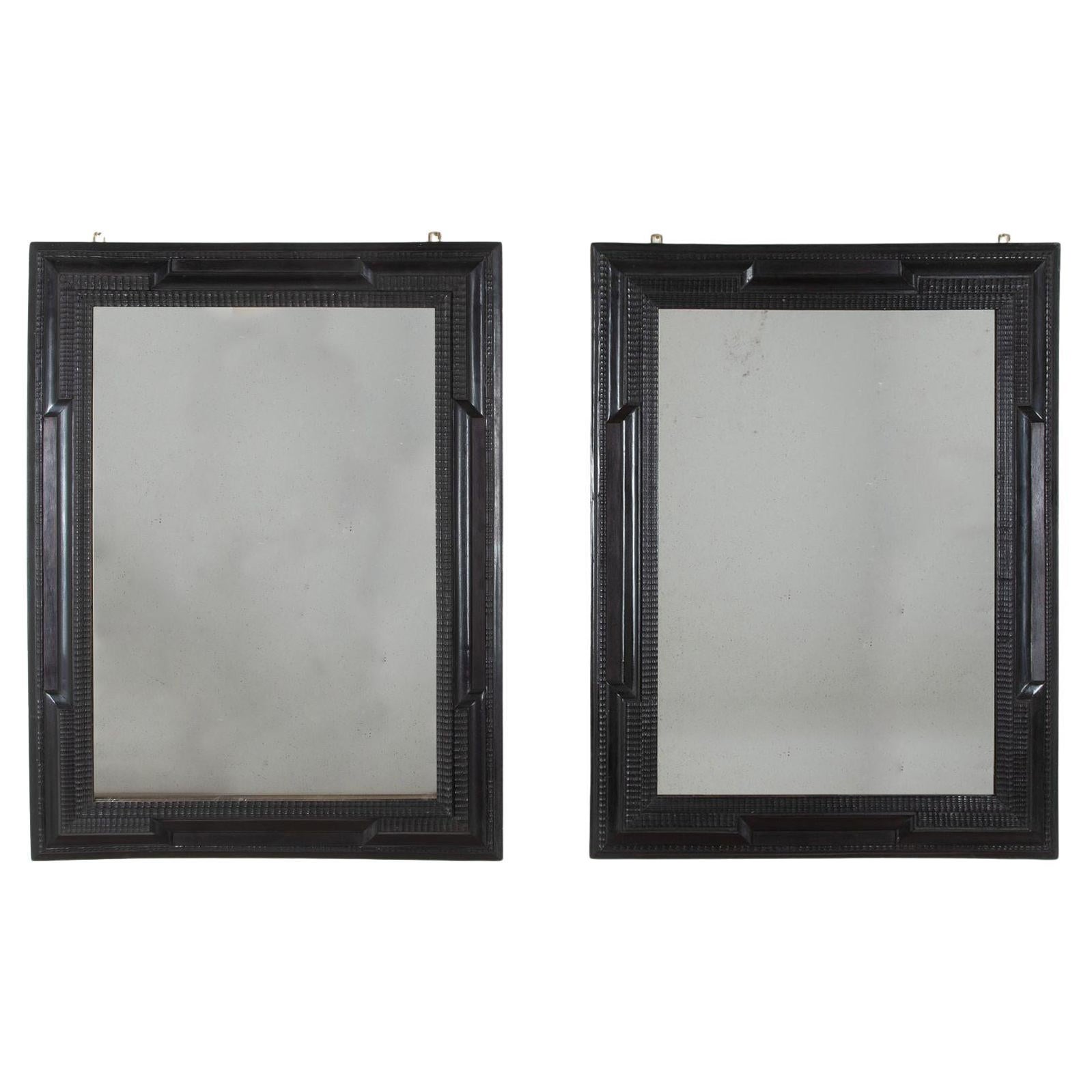 Pair of 20th Century Spanish Ebonised Ripple Moulded Mirrors For Sale