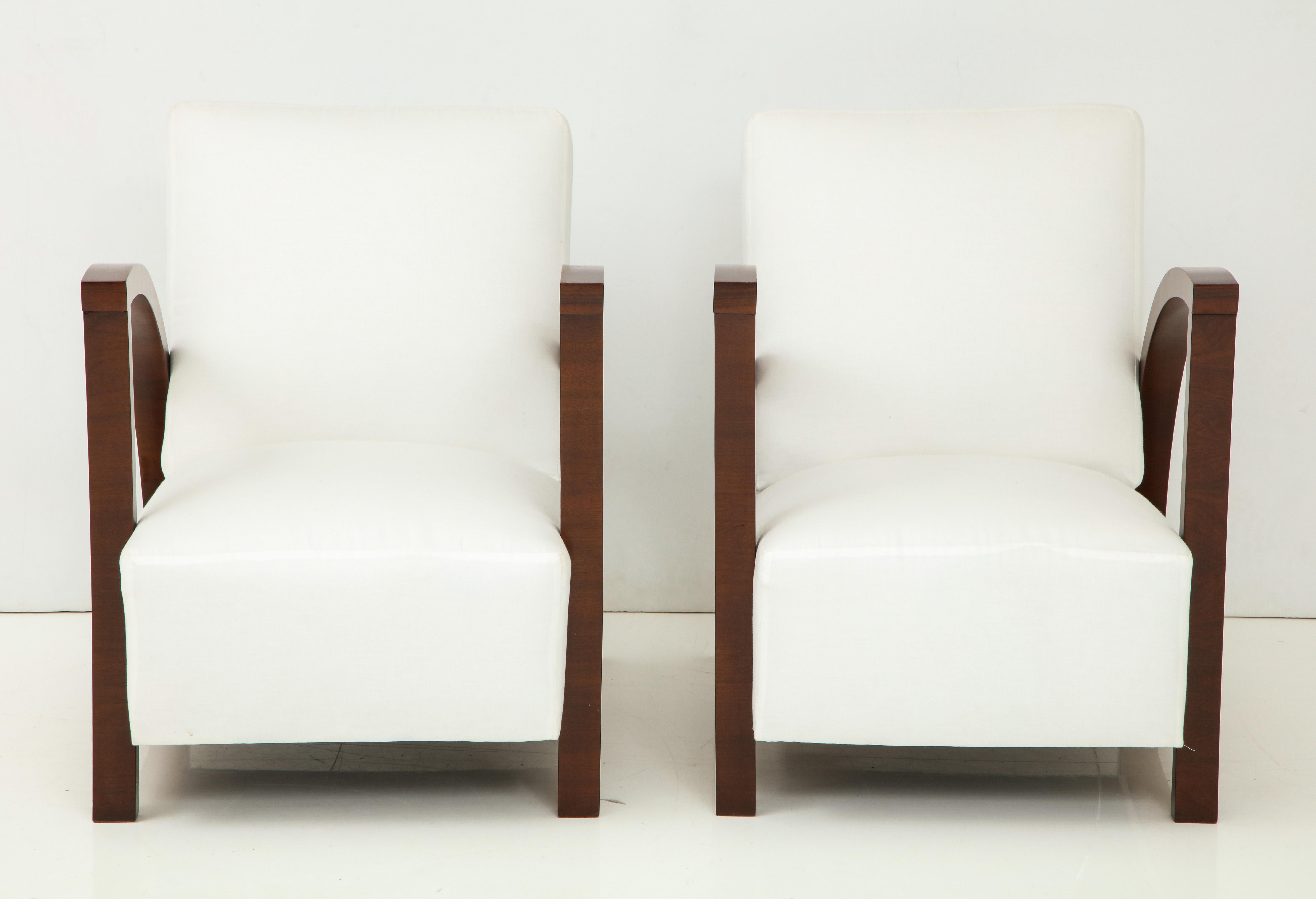 Pair of 20th century teak wood armchairs with flat-front arms.