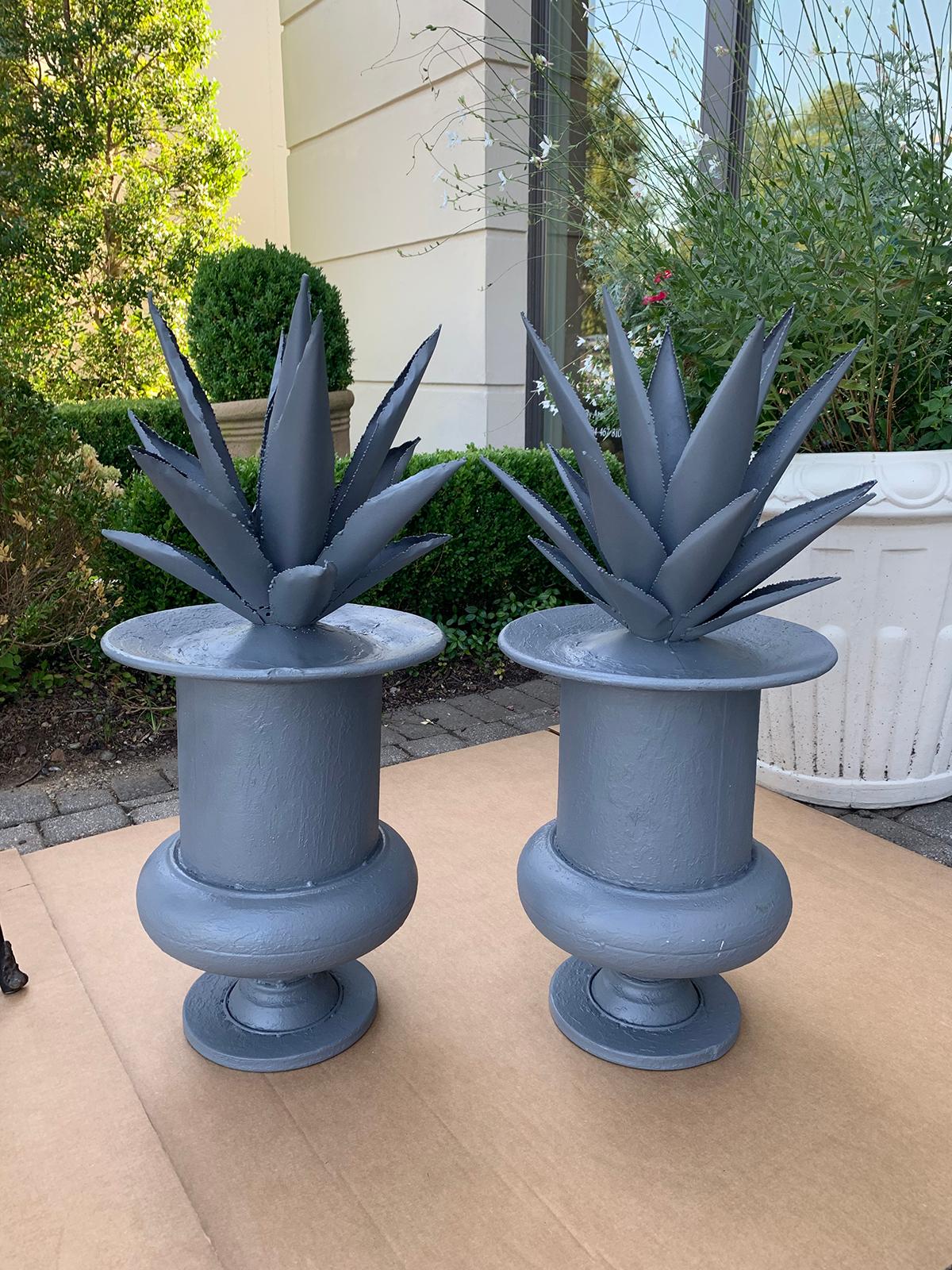 Pair of 20th century tole agaves in urns, painted.