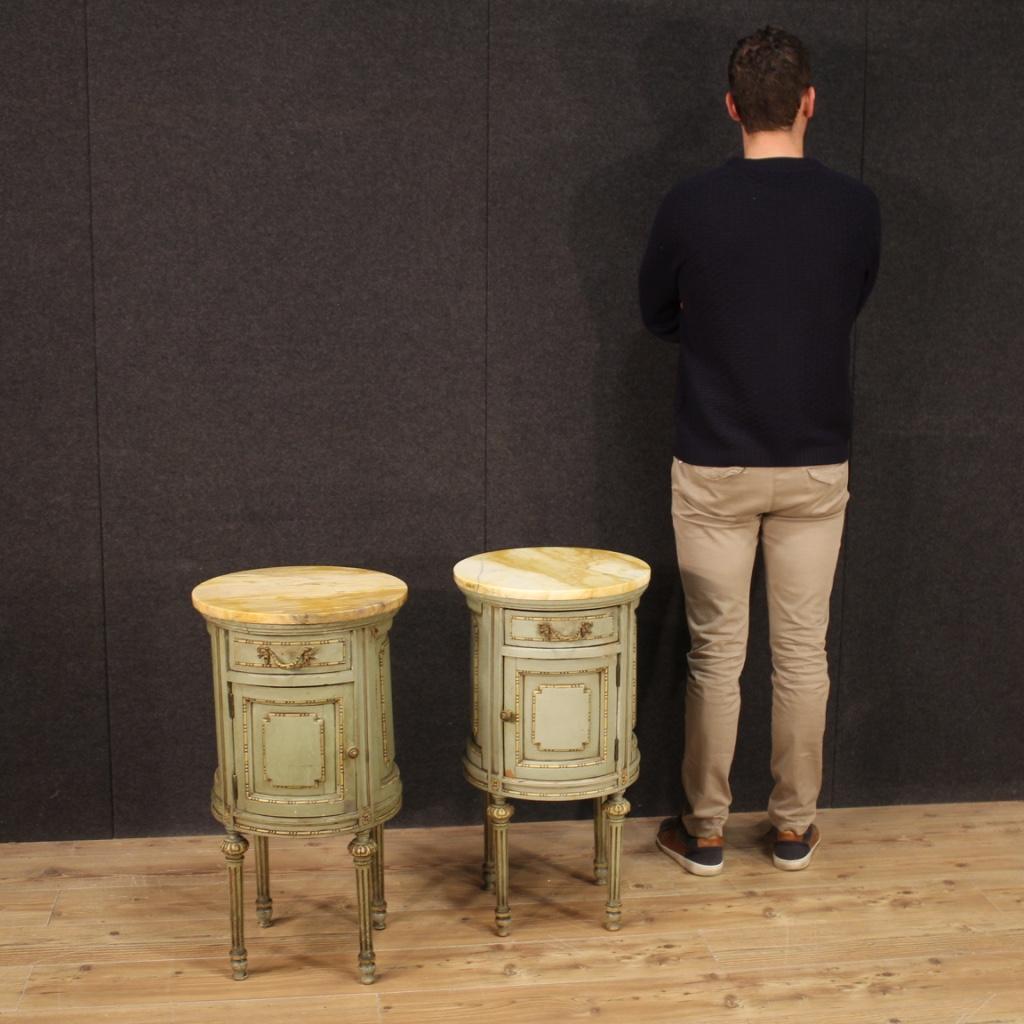 Pair of Italian cylinder bedside tables from the mid-20th century. Furniture in Louis XVI style in finely chiseled and lacquered wood. Nightstands complete with marble tops of good size and service. A marble top has undergone a restoration (see