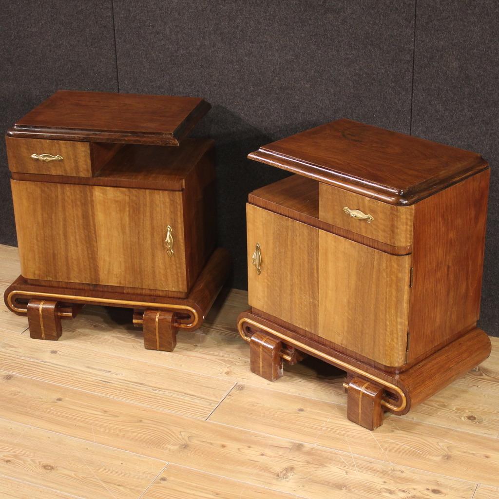 Pair of Italian bedside tables from the mid-20th century. Art Deco style walnut, mahogany, maple and fruitwood veneer furniture. Bedside tables equipped with a drawer, a door with a large internal compartment, an upper support shelf and a magazine