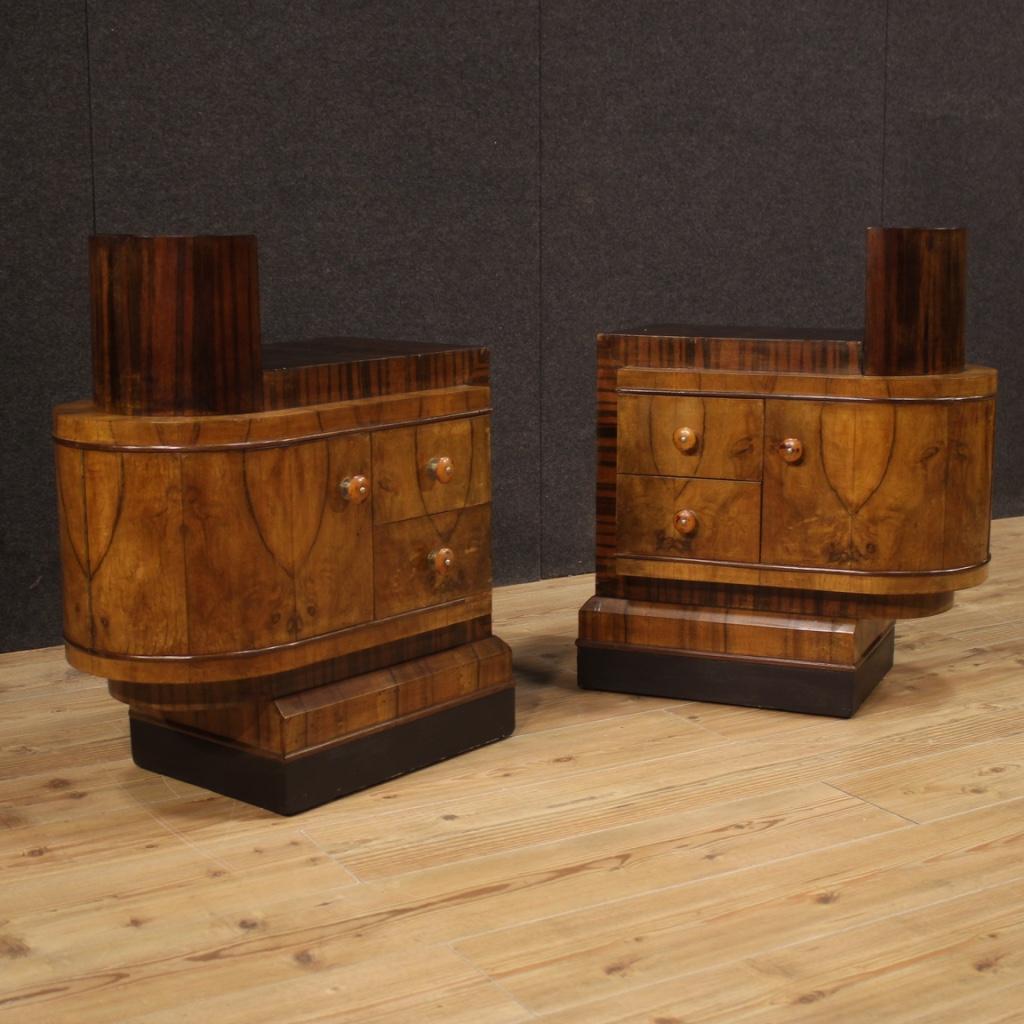Particular pair of Italian bedside tables from the mid-20th century. Furniture veneered in palisander, walnut, burl, ebonized wood and fruitwood of fabulous line and pleasant decor. Art Deco bedside tables equipped with two drawers and a door of