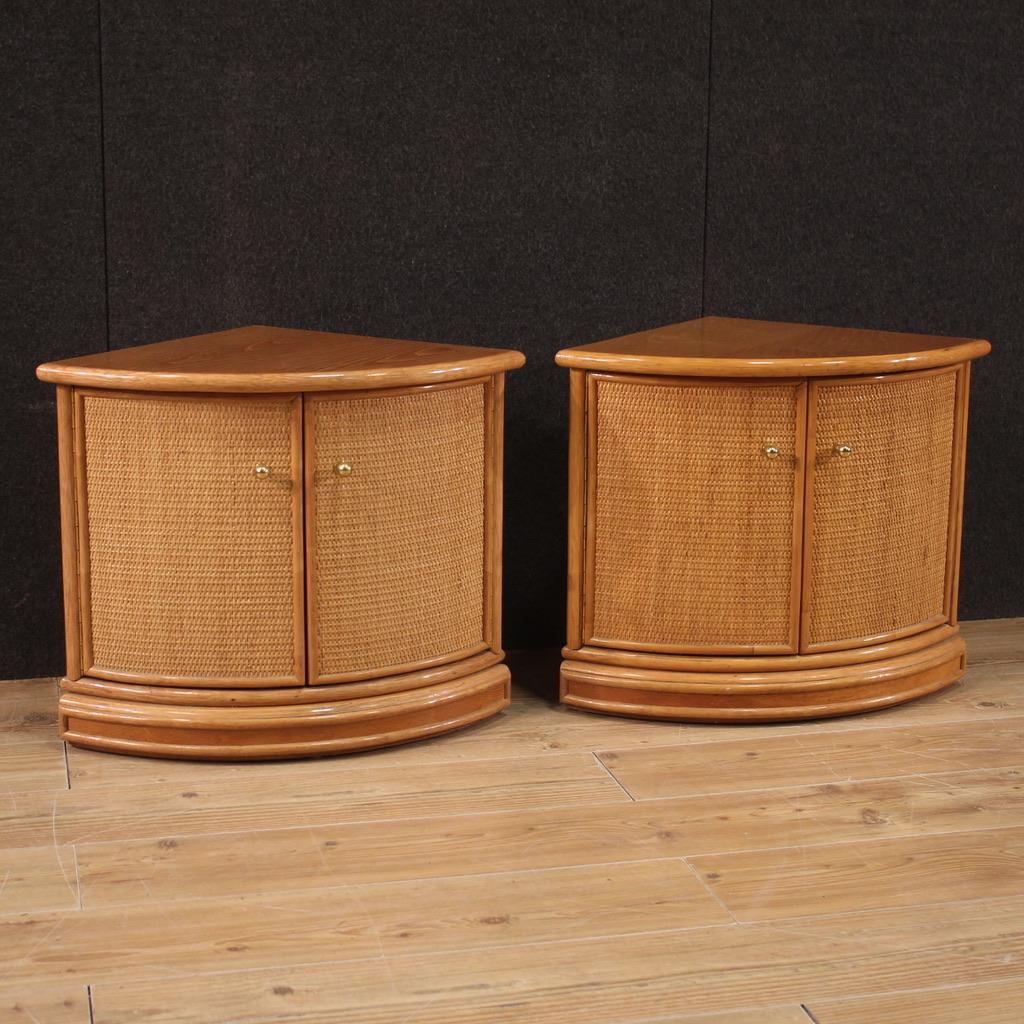 Pair of Italian corner cabinets from the 1970s-1980s. Designer furniture, in exotic wood and rattan, with golden metal knobs. Corner cabinets finished from the center with a fairly large wooden top. Furniture with two doors that offer inside a