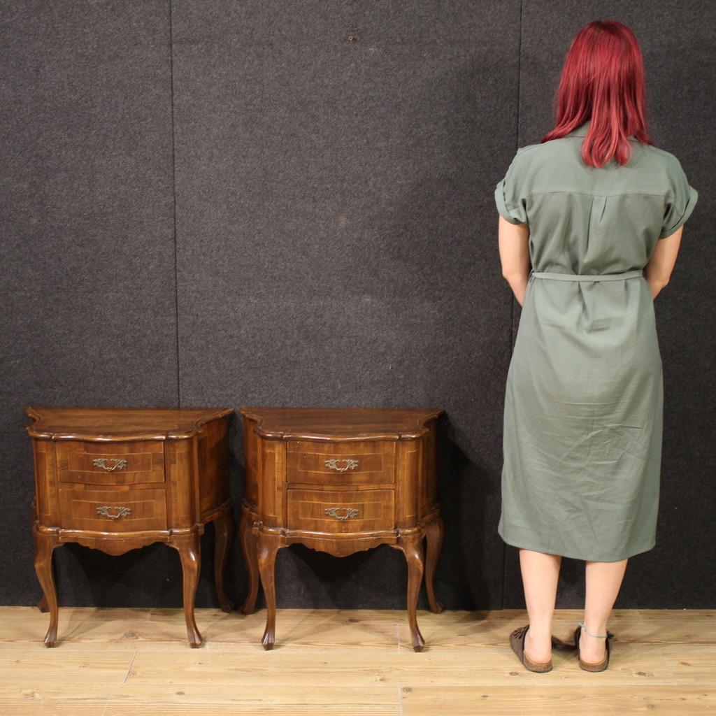 A pair of Venetian bedside tables from the mid-20th century. Furniture of small dimensions, each with two drawers, are veneered in walnut and maple. These tall-legged tables, complete with a wooden top, are of a discreet size and practicality. These