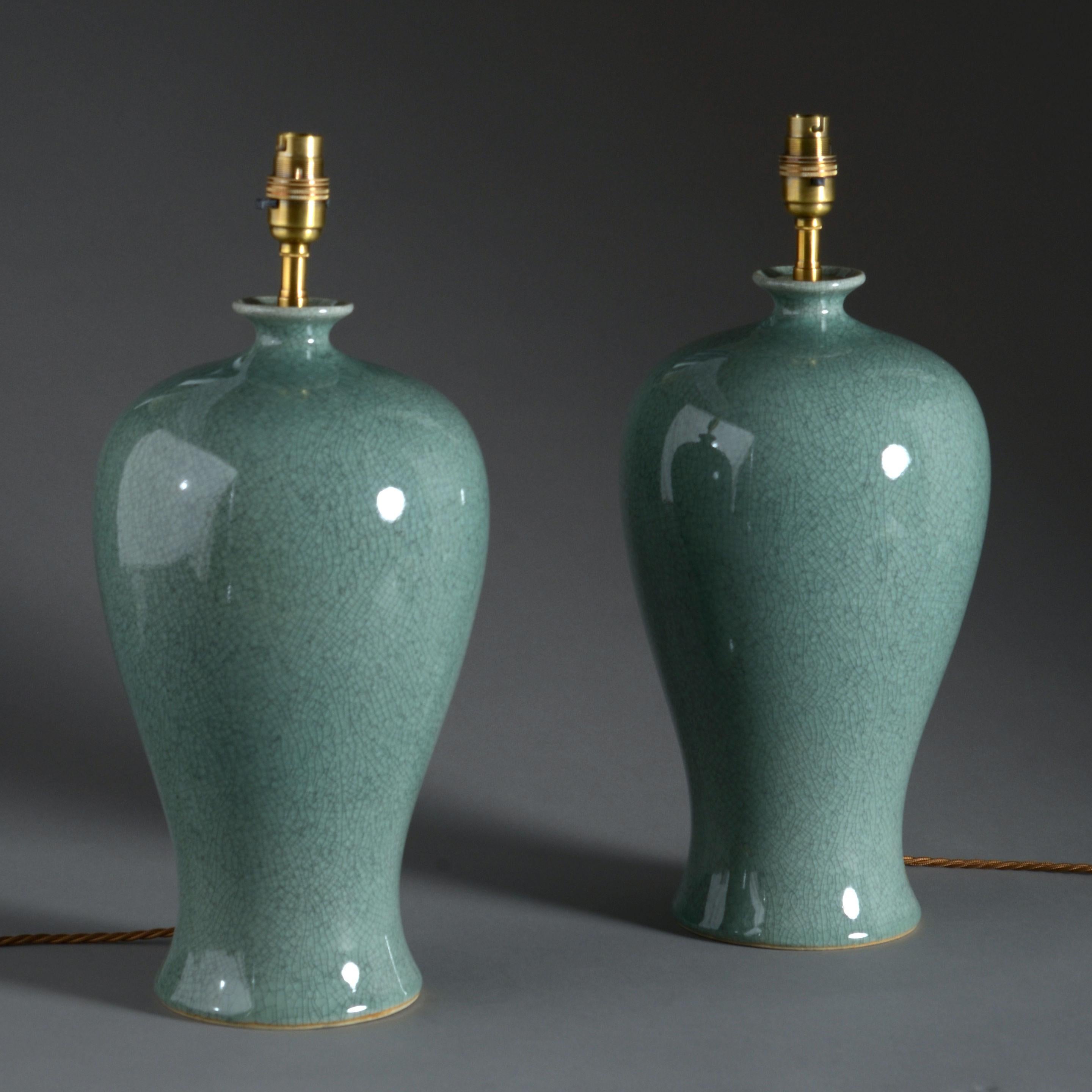 A pair of celadon crackle glazed porcelain vases mounted as table lamps.