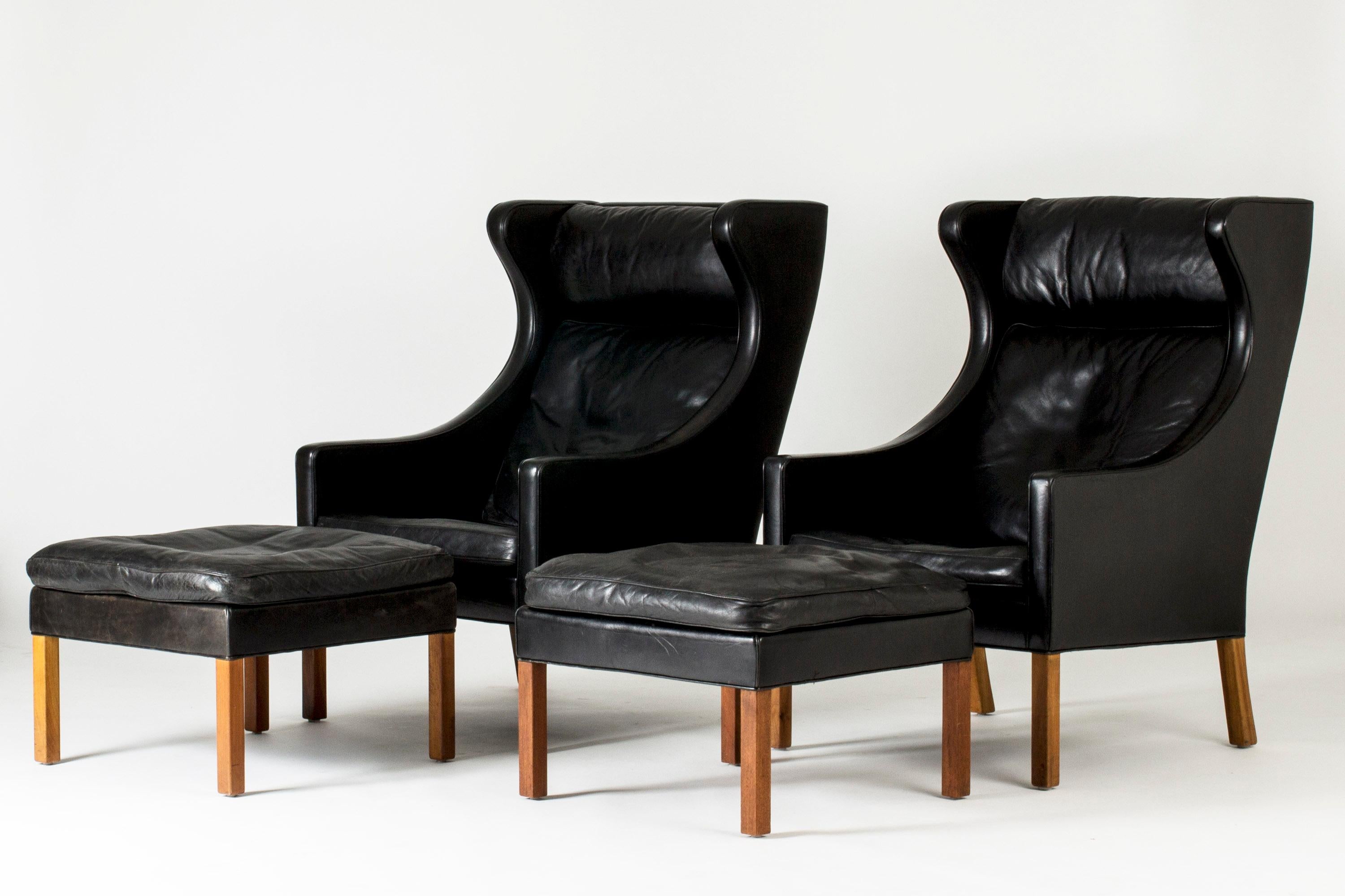 Pair of “2204” lounge chairs with ottomans by Børge Mogensen. Elegant, bold lines. Comfy and relaxing to be seated in.

Measures: Height 105 cm (chairs), 40 cm (ottomans)
Width 70 cm (chairs), 60 cm (ottomans)
Depth 80 cm (chairs), 60 cm