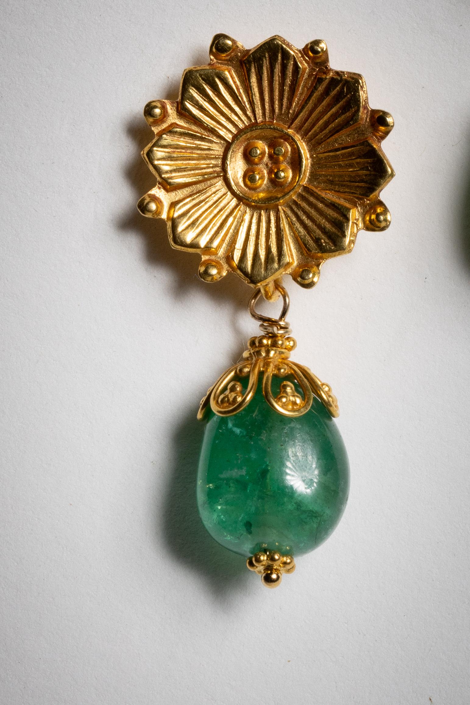 A stunning pair of 22K gold drop earrings with a hand-tooled flower motif on the stud.  A wire-work end cap sits on top of a Colombian tumbled emerald.  For pierced ears.  Designed and made by Deborah Lockhart Phillips.

The fine jewelry collection