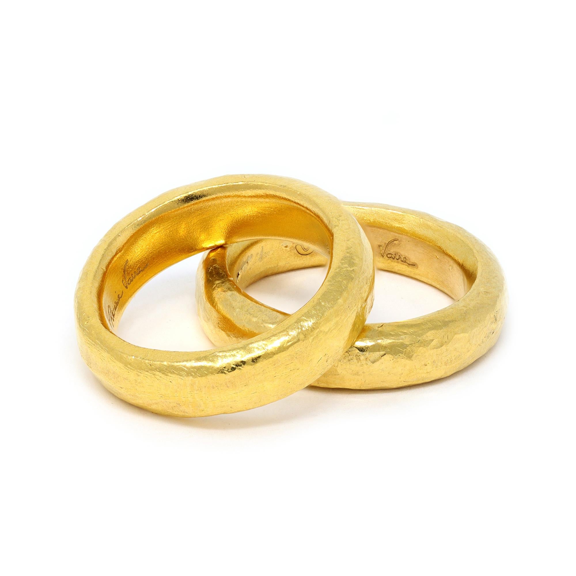 A lovely pair of handmade 24 karat gold band rings by Rosaria Varra. The 24k pure gold make these bands substantially hefty in weight, 28.5 grams together. They are size is 7 and 7½, sit gracefully on the finger and can be paired with other bands.