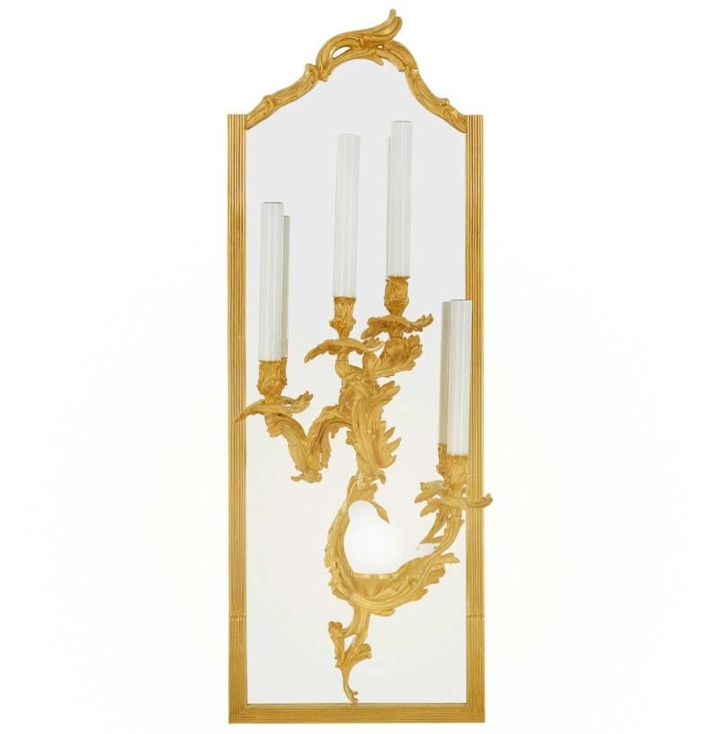 These Rococo-style sconces by Eric Stepniewski are truly exceptional pieces that blend classical artistry with innovative design elements. Here's a more detailed description, building on your provided text:

Immerse yourself in the captivating