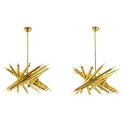 Pair of 24-light chandeliers in patinated brass. 1980s.