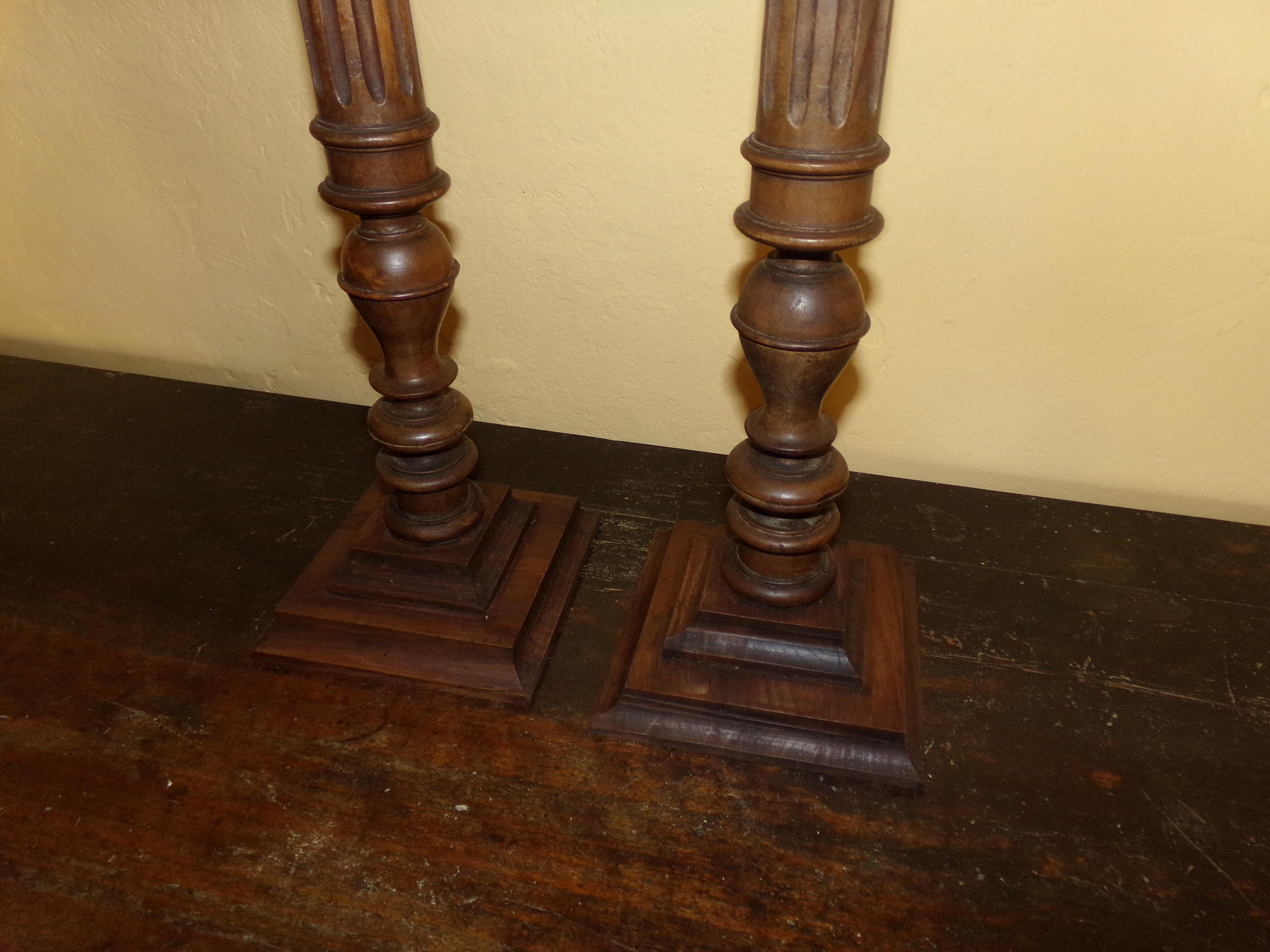 A super pair of turned, carved and fluted pricket walnut candlesticks in the Louis XVI style beautifully crafted from original circa 1890s wood turnings. Our craftsman has retained all the original patination. A beautiful holiday gift for all the