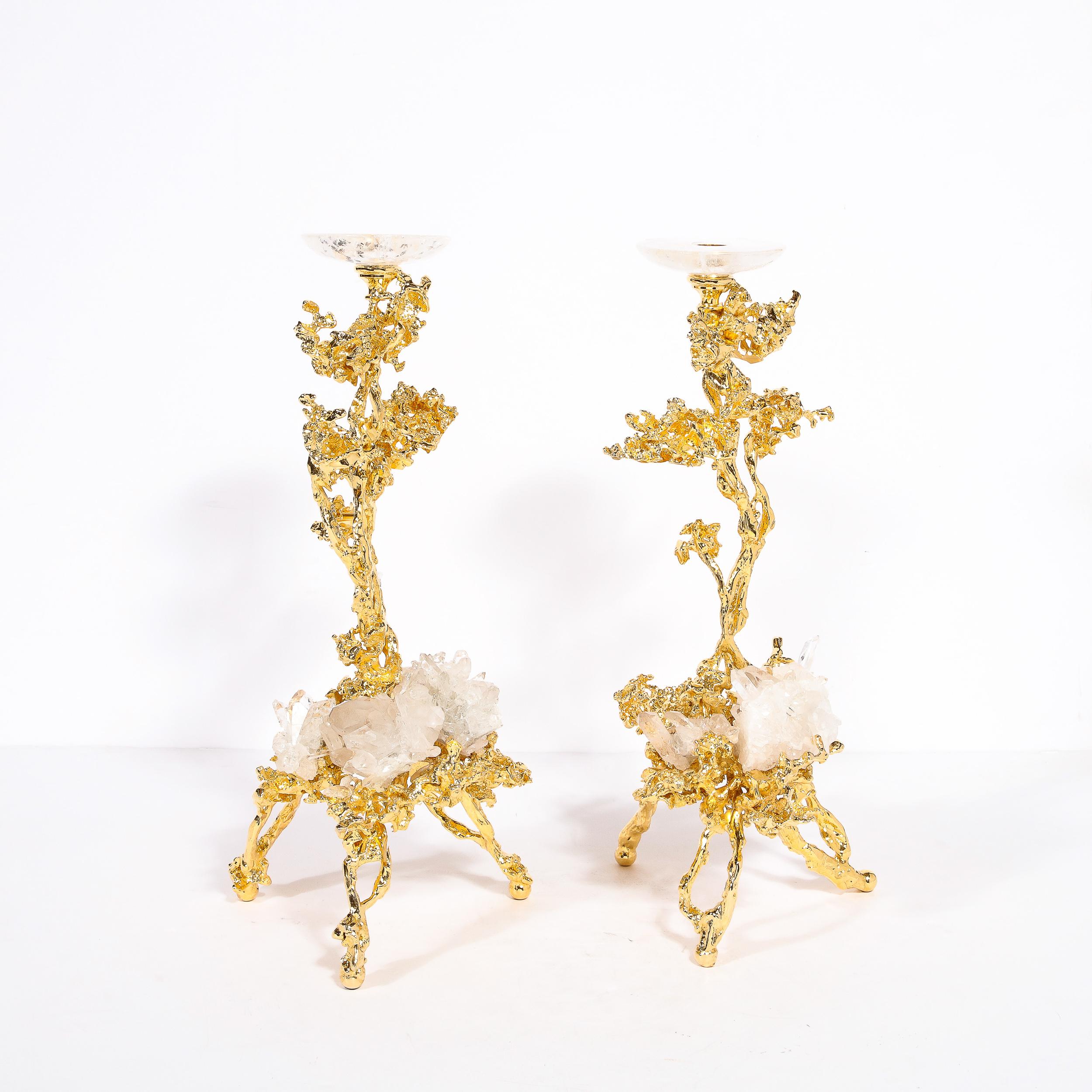 This dramatic and stunning pair of modernist candlesticks were realized in France by the esteemed artisan Claude Victor Boeltz. They offer an exploded form sculpted, by hand, and cast in bronze, consisting of a single arm and three feet plated in