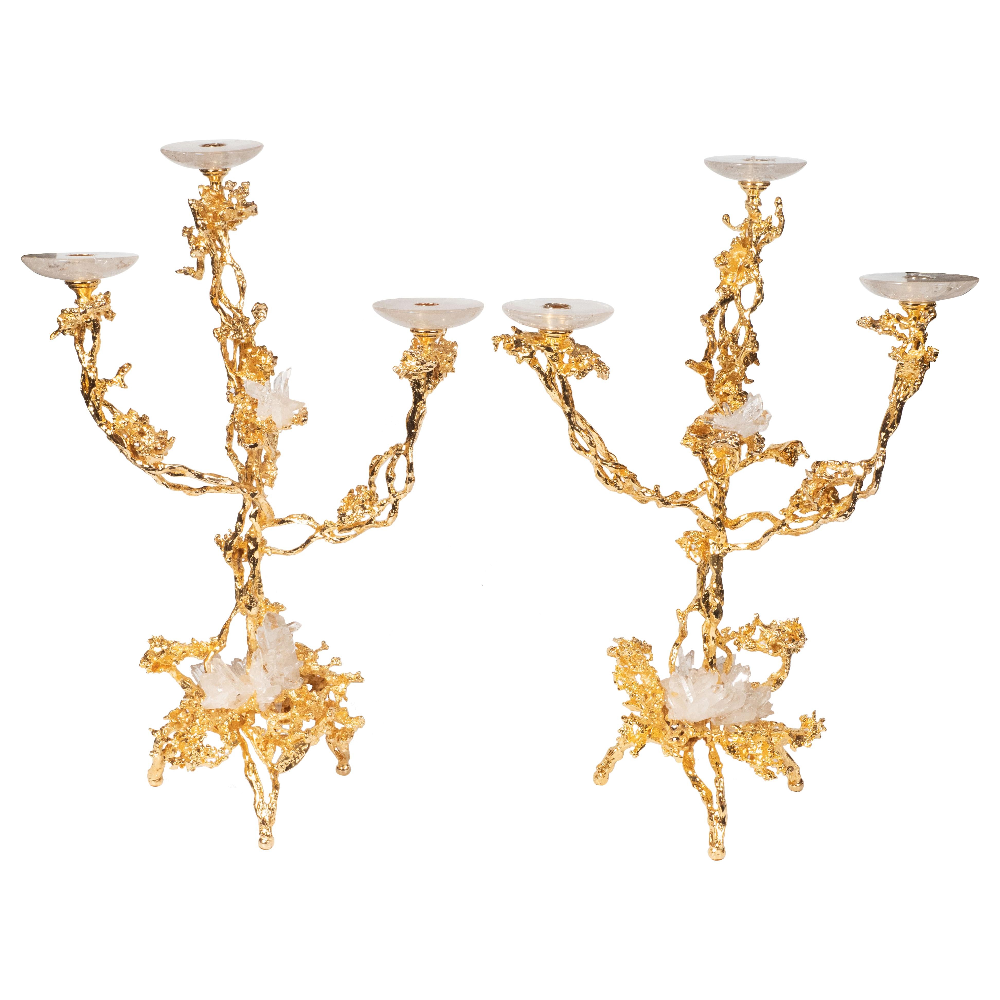 This stunning pair of Mid-Century Modern candlesticks were realized in France by the esteemed artisan Claude Victor Boeltz. They offer an exploded form sculpted, by hand, and cast in bronze, consisting of two arms and three feet plated in 24-karat