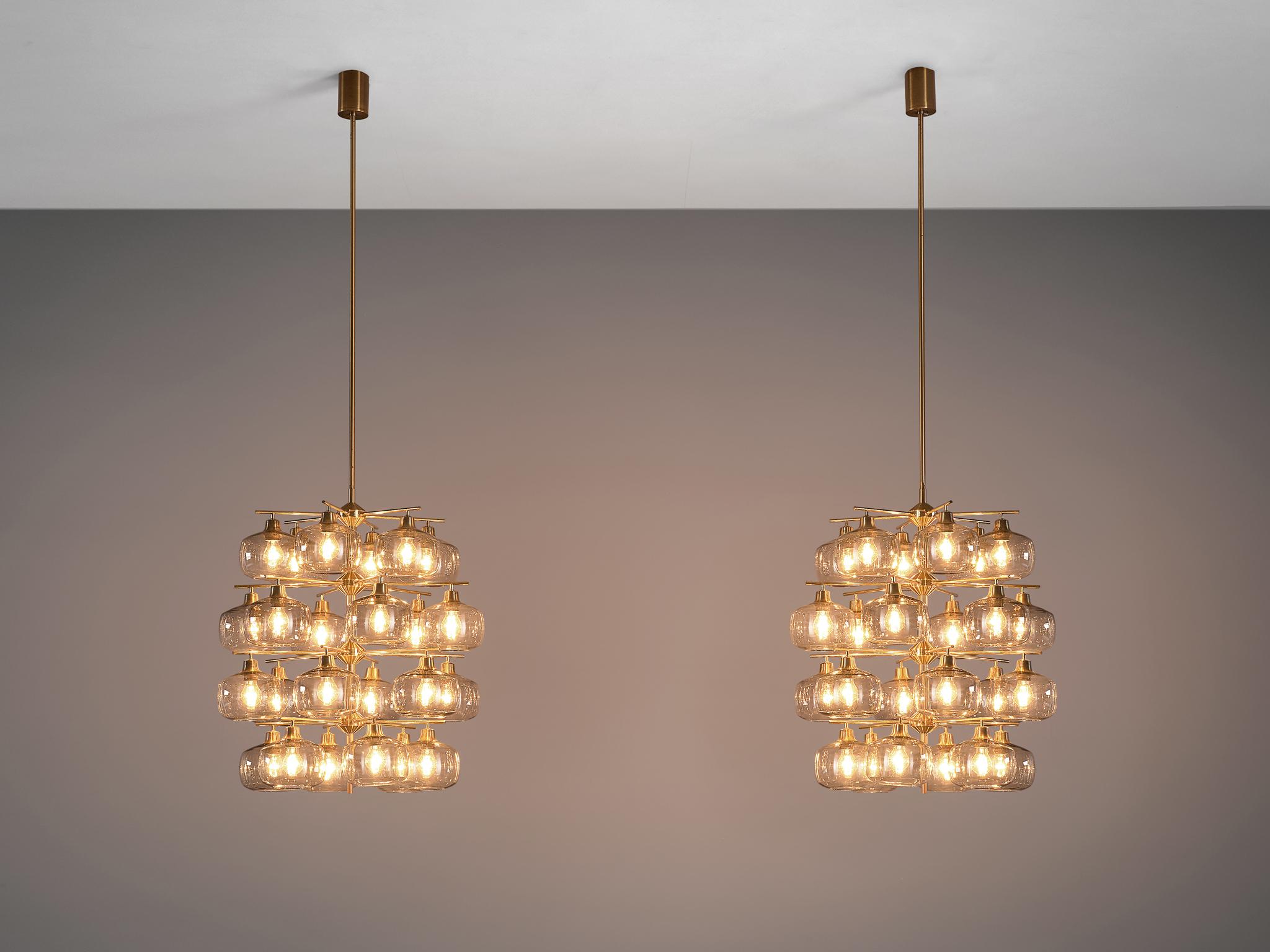 Holger Johansson for Westal, pair of chandeliers, brass, smoked glass, Sweden, 1952. Measures: 2mtr/82.5in high.

This exceptional chandelier by Holger Johansson is rare in its kind and size. In 1952 the chandelier was custom-made for the
