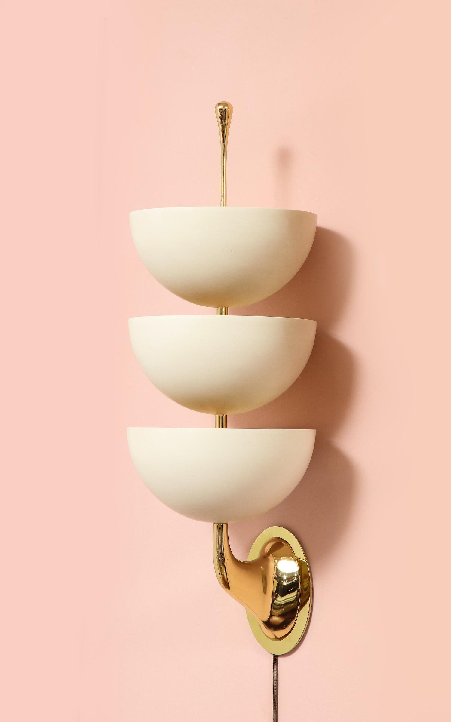 Painted aluminum, brass. Classic Stilnovo forms comprised of painted metal cups & polished brass stylized supports. Each sconce has 9 x E12, (candelabra) sockets concealed inside of the 3 painted cups. Each light is signed on the finial.  **2nd