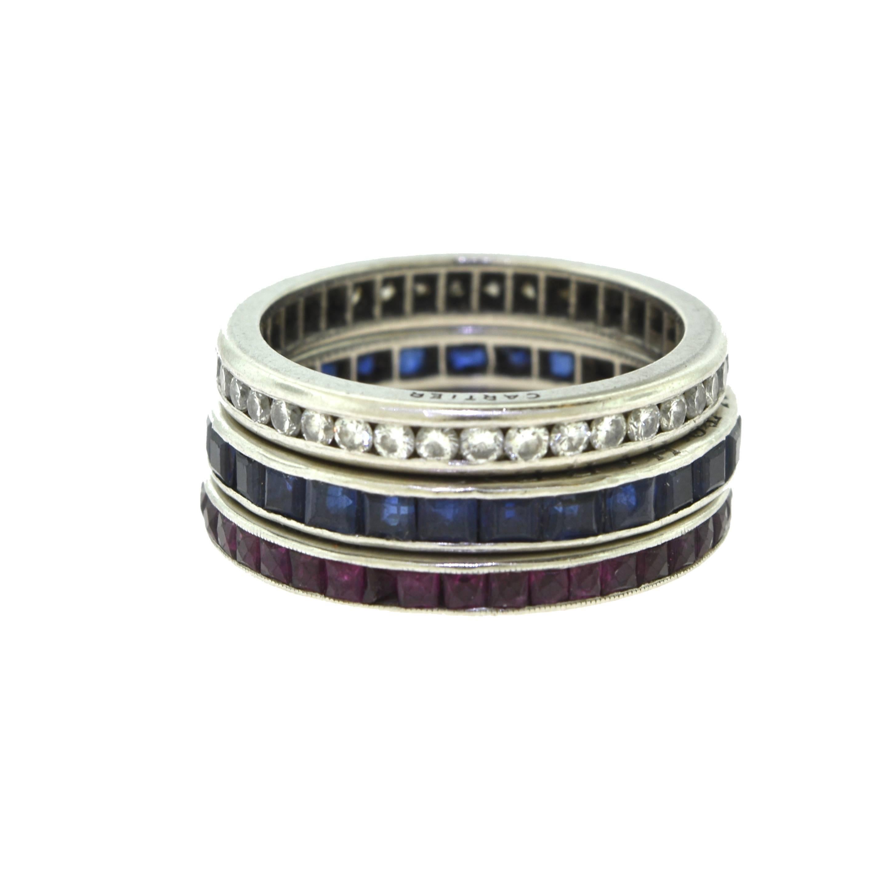 Set of Three Cartier Rings, Very Vintage from the 1950's. 
Each ring features a row of either rubies, sapphires, and diamonds.

Diamond Ring:
3.4 grams
2.74 mm band width.
Ring Size: 6

Ruby Ring:
3.2 grams
2.09 mm band width.
Ring Size: 6

Sapphire
