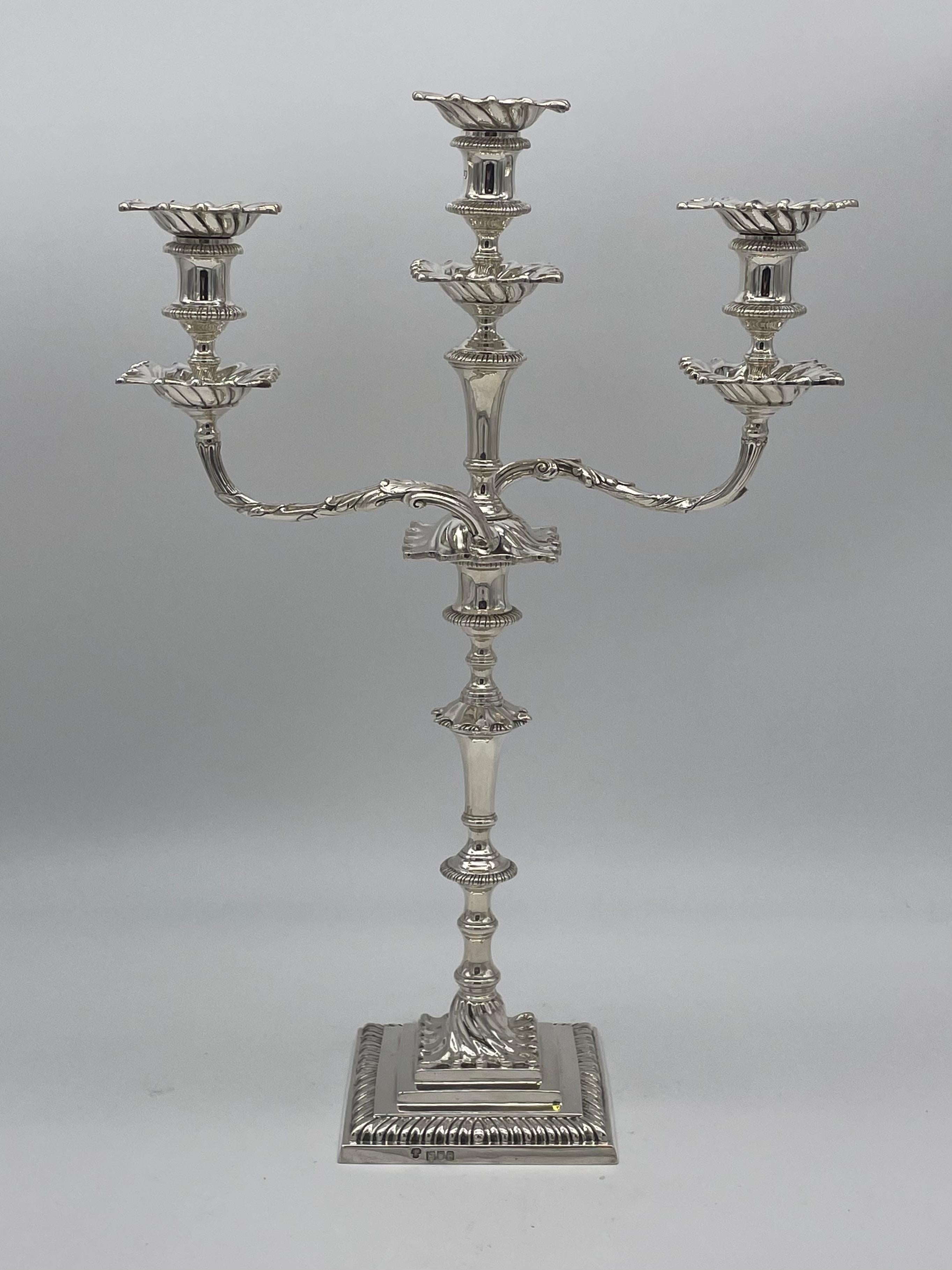 A pair of antique English sterling silver candelabra of cast form with a total weight of 3090gm.
These candelabra in London, 1913, to a style of candlestick first seen in the mid eighteenth century.
The arms, or branches remove, in order that the